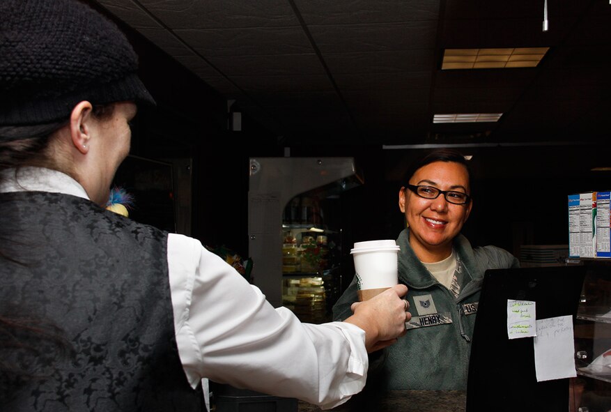 Tech. Sgt. Helen Henry, Flight Medical Technician for the 911th Airlift Wing Aeromedical Evacuation Squadron, (right), receives her morning coffee at Perksburgh from Club Staffer, Amy McVay, Dec. 20, 2012.  Perksburgh, an on-base café that serves Starbucks coffee, will be undergoing a renovation that will improve services to its customers by bringing two points of sale to expedite checkouts efficiently, a greater variety of menu choices, a wireless internet bar and an aesthetics update. Any Airmen on UTA status, from Dec. 24 – Jan. 1 will receive a meal voucher for Eat N Park.  Please have your requests in by 10 a.m., Dec. 21 for meal vouchers.  Vouchers can be picked up at the Dining Facility, Bldg. 213, Room 106 from 11 a.m. until 2 p.m., Dec. 21, 2012.  Club Cargo Bay will be open for Troop Feeding January 2 and 3, 2013 with a limited menu.  Box dinner's will be available upon request and must be ordered by 11 a.m. on the day needed and picked up by 1 p.m. that day. Along with the Troop Feeding, the Club will be having dining available from 6:30 a.m. to 1:30 p.m. from Jan. 2 until Jan. 4, Perksburgh style except for Starbucks items. (U.S. Air Force photo by Senior Airman Justyne Obeldobel/Released)