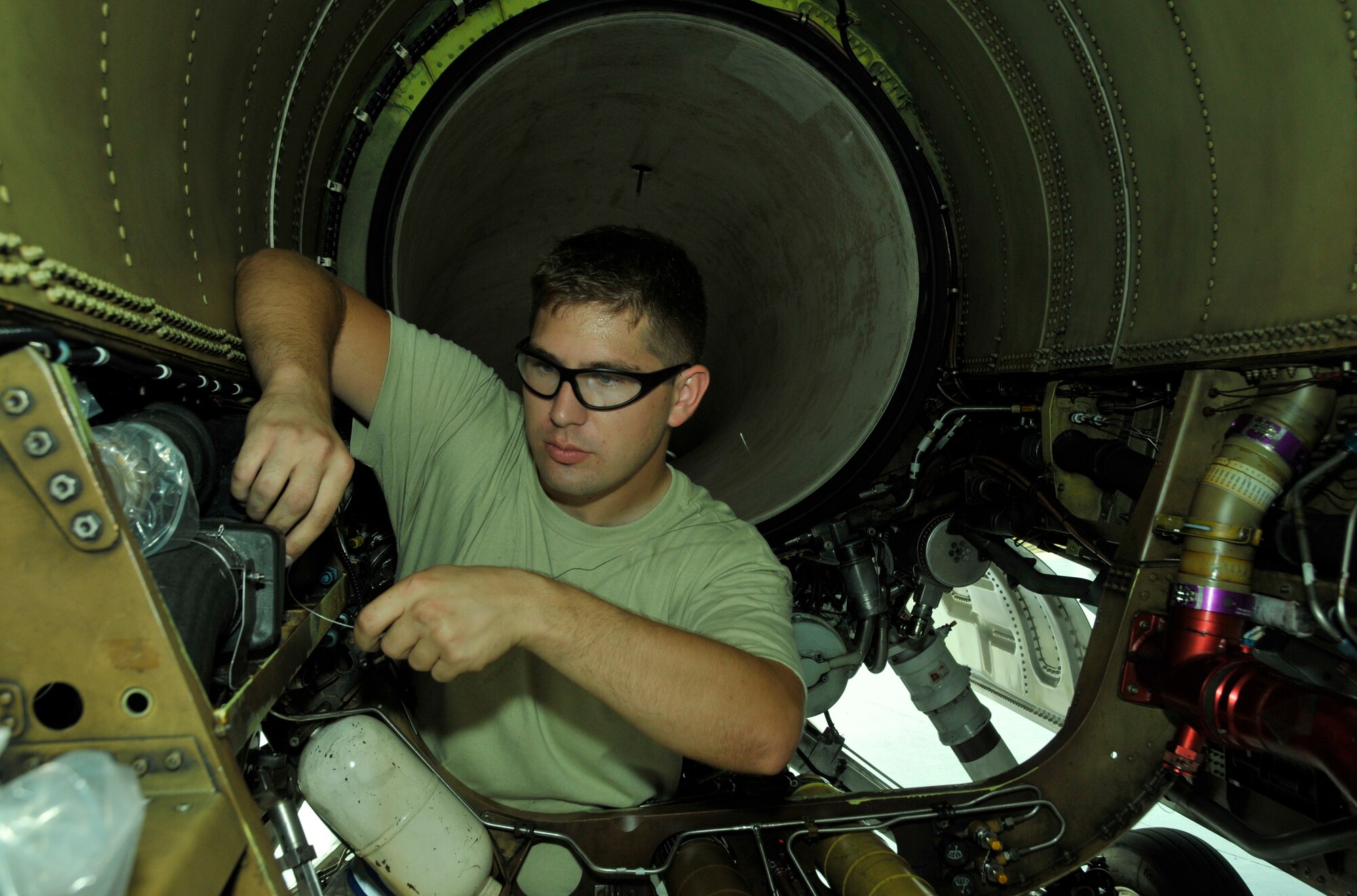 Airman 1st Class James Brewer, 482nd Aircraft Maintenance Squadron crew chief, repairs safety wire on a vent during an engine bay inspection of an F-16 at Homestead Air Reserve Base, Fla., Dec. 11. (U.S. Air Force photo/Senior Airman Jacob Jimenez)