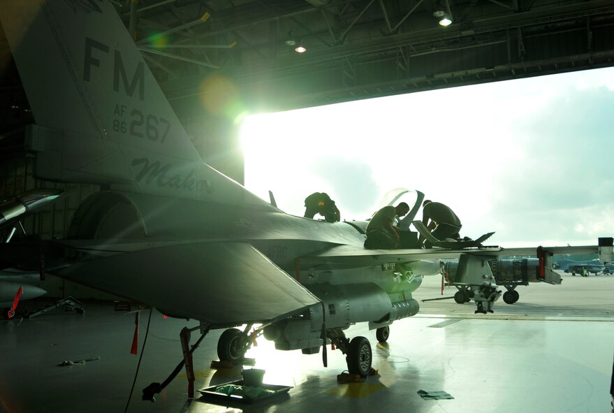 (from left) Senior Airman Jose Rocha, 482nd Aircraft Maintenance Squadron crew chief, installs a horse-shoe panel while Tech. Sgt. Warren Hillmuth, 482nd Maintenance Squadron Aircraft Structural Maintenance, and Tech. Sgt. Erick Camacho, 482nd Maintenance Squadron Aircraft Structural Maintenance, perform a structural inspection on an F-16 at Homestead Air Reserve Base, Fla., Dec. 11. (U.S. Air Force photo/Senior Airman Jacob Jimenez)