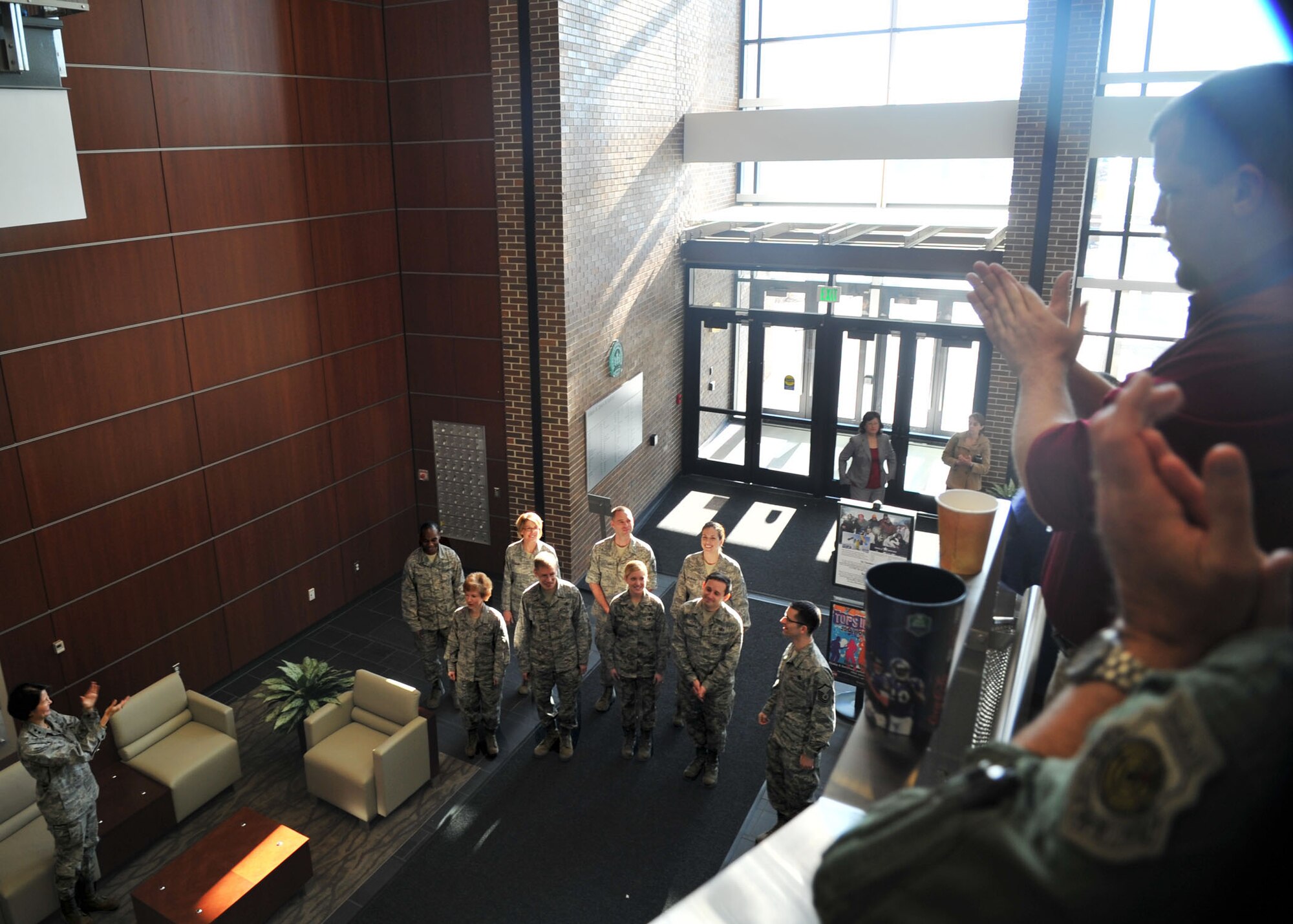 Air Force District of Washington Commander Maj. Gen. Sharon K.G. Dunbar and AFDW Airmen applaud the United States Air Force Band Singing Sergeants after they finished singing holiday carols throughout the Jones Building at Joint Base Andrews, Md. Dec. 18, 2012. (U.S. Air Force photo by 1st Lt. Ashleigh Peck)