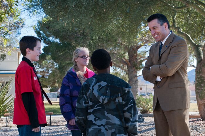 Caleb Sanders, Karlee Brennan, and B.J. Phillips speak to Nevada Governor Brian Sandoval Dec. 19th, 2012, at Nellis Air Force Base, Nev. Sandoval visited Lomie Heard Elementary School to speak with faculty about facilities and day-to-day routines. (U.S. Air Force Photo by Airman 1st Class Jason Couillard)