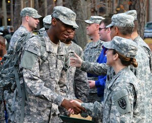 U.S. Army Pfc. Xavier Hopkins, a human resources specialist with 3rd Platoon, 510th Human Resources Company, Special Troops Battalion, 7th Sustainment Brigade, shakes hands with Col. Jennifer Reinkober, the 7th Sus. Bde. commander, as the 3rd Plt., 510th HRC departs Fort Eustis, Va., to begin a nine-month deployment to Kuwait, Dec. 8. While in Kuwait, the Soldiers will be responsible for the accountability of all Soldiers coming in and out of theater. (U.S. Army photo by Sgt. Edwin Rodriguez/Released)