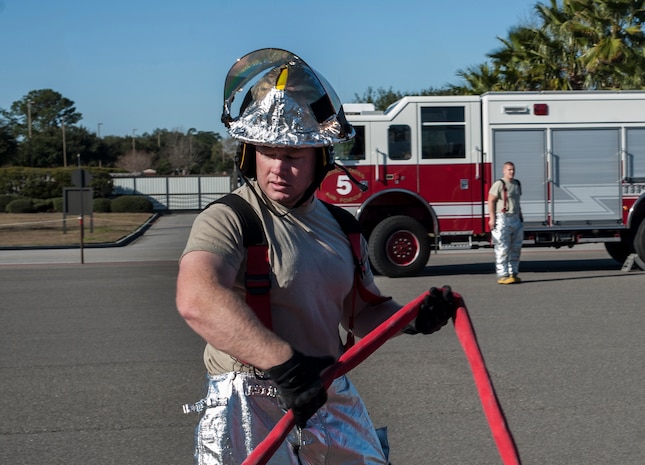 Tech. Sgt. Cory Bowers, 628th Civil Engineer Squadron firefighter, brings in a hose after a C-17  Globemaster III emergency response drill  Dec. 19, 2012, at Joint Base Charleston - Air Base, S.C. During theGlobemaster III drill, firefighters practiced for a real life situation such as a plane crash with a fire, smoke and casualties.  The drill takes place eight times a year. (U.S. Air Force photo/ Airman 1st Class Ashlee Galloway) 