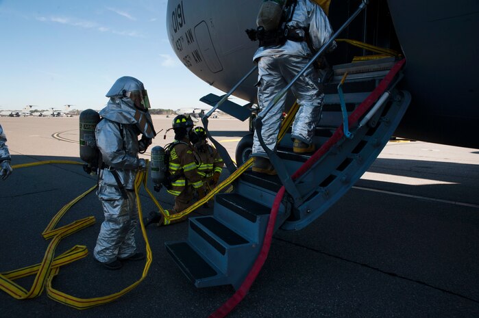Firefighters from the 628th Civil Engineer Squadron take part in a C-17  Globemaster III emergency response drill  Dec. 19, 2012, at Joint Base Charleston - Air Base, S.C. During the Globemaster III drill, firefighters practiced for a real life situation such as a plane crash with a fire, smoke and casualties.  The drill takes place eight times a year. (U.S. Air Force photo/ Airman 1st Class Ashlee Galloway)