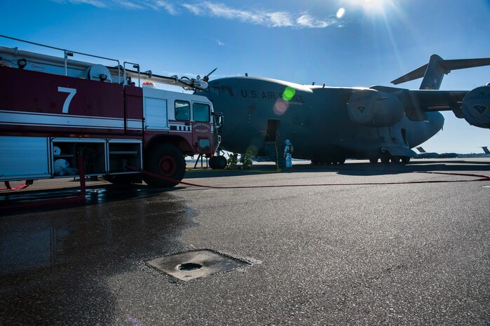 Firefighters from the 628th Civil Engineer Squadron take part in a C-17 Globemaster III emergency response drill Dec. 19, 2012 at Joint Base Charleston - Air Base, S.C. During the C-17 Globemaster III drill, firefighters practiced for a real life situation, such as a plane crash with a fire, smoke and casualties. The drill takes place eight times a year. (U.S. Air Force photo/ Airman 1st Class Ashlee Galloway) 
