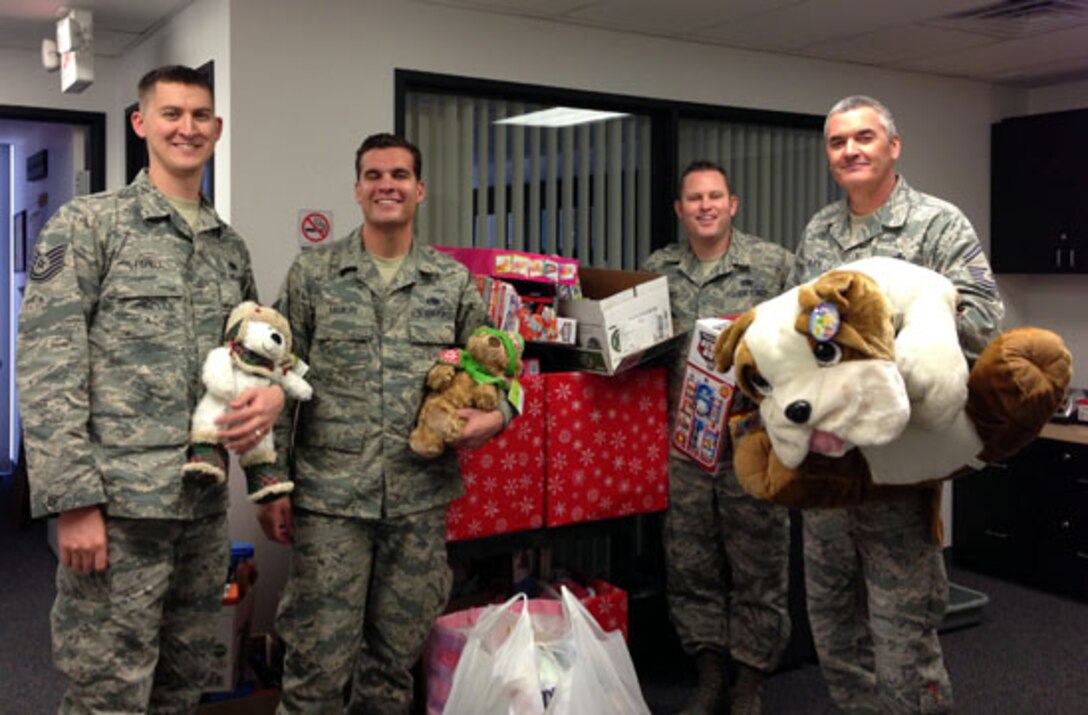 LAS VEGAS, Nev. -- (Left to right) Tech. Sgt. Caleb Fishell, Tech. Sgt. Donald McGurk, Master. Sgt. Jonathan Jundt and Senior Master Sgt. Joseph Golden from the 926th Aircraft Maintenance Squadron deliver toys to the Children's Specialty Center's Cure 4 The Kids Foundation on Dec. 19. The unit held a drive that collected seven boxes and three bags of toys for the foundation's holiday party. The foundation addresses children's specialized health care needs and fosters clinical research for the cure and prevention of all types of childhood diseases. (Information collected from cure4thekids.org.) (courtesy photo)