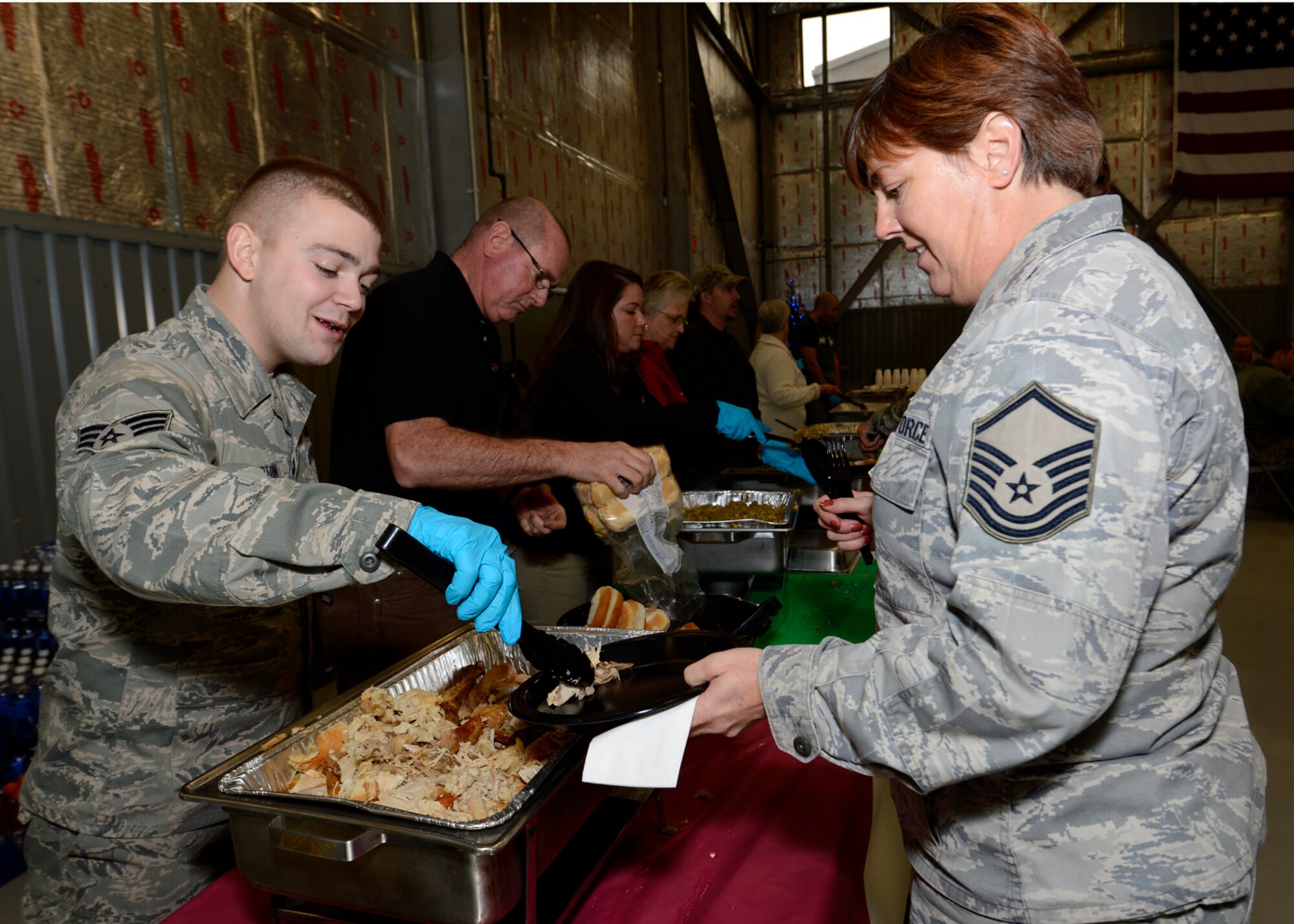 Senior Airman Wesley Crampton, 712th Aircraft Maintenance Squadron aircraft
hydraulics specialist, serves turkey to Master Sgt. Cheryl Dillon, 512th
Maintenance Squadron ISO Specialist Section Chief, Dec. 21, 2012, at
Hangar 729 on Dover Air Force Base, Del. Civilian employees, community
members and Dover International Speedway prepared the meal to honor the
Airmen of Dover AFB for the holidays. (U.S. Air Force photo by Tech. Sgt.
Chuck Walker)
