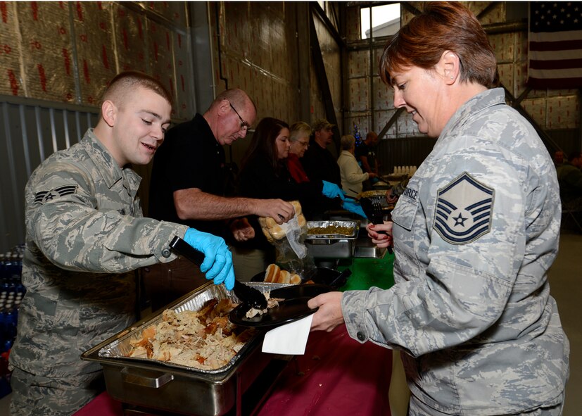 Senior Airman Wesley Crampton, 712th Aircraft Maintenance Squadron aircraft
hydraulics specialist, serves turkey to Master Sgt. Cheryl Dillon, 512th
Maintenance Squadron ISO Specialist Section Chief, Dec. 21, 2012, at
Hangar 729 on Dover Air Force Base, Del. Civilian employees, community
members and Dover International Speedway prepared the meal to honor the
Airmen of Dover AFB for the holidays. (U.S. Air Force photo by Tech. Sgt.
Chuck Walker)
