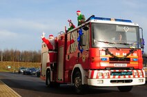 DUXFORD IMPERIAL WAR MUSEUM, England – Santa Claus and his elves arrive by fire truck during a children’s Christmas party at the Duxford Imperial War Museum in Cambridge, United Kingdom, Dec. 15, 2012. The 492nd Fighter Squadron hosted this year’s annual children’s Christmas party, which was attended by more than 40 children including many from U.K. hospitals. (U.S. Air Force photo/Airman 1st Class Cory D. Payne)