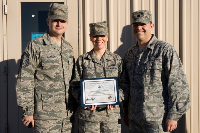 U.S. Air Force Lt. Col. Gabriel Lopez, 99th Logistics Readiness Squadron commander, and Senior Master Sgt. Jayme Jackson, 99th Logistics Readiness Squadron first sergeant, present the Diamond Sharp Award to Staff Sgt. Mandy Hilton, 99th Logistics Readiness Squadron knowledge operations NCO in charge Dec. 21, 2012, at Nellis Air Force Base, Nev. Hilton established a new automated job tracking system, resulting in a 99 percent on time rate. Additionally she served as the 99th LRS Aviation Nation representative, raising more than $2k for squadron events. (U.S. Air Force photo by Airman 1st Class Christopher Tam)
