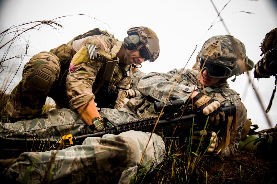 U.S. Air Force Airman 1st Class Austen Carroll, 38th Rescue Squadron pararescueman, applies a tourniquet to Airman 1st Class Kyle McNamara, 823d Base Defense Squadron fire team member, during a training mission at Avon Park Air Force Range, Fla., Dec. 13, 2012. The Airmen and their units took part in various scenarios for three days at Avon Park. (U.S. Air Force photo by Staff Sgt. Jamal D. Sutter/Released) 