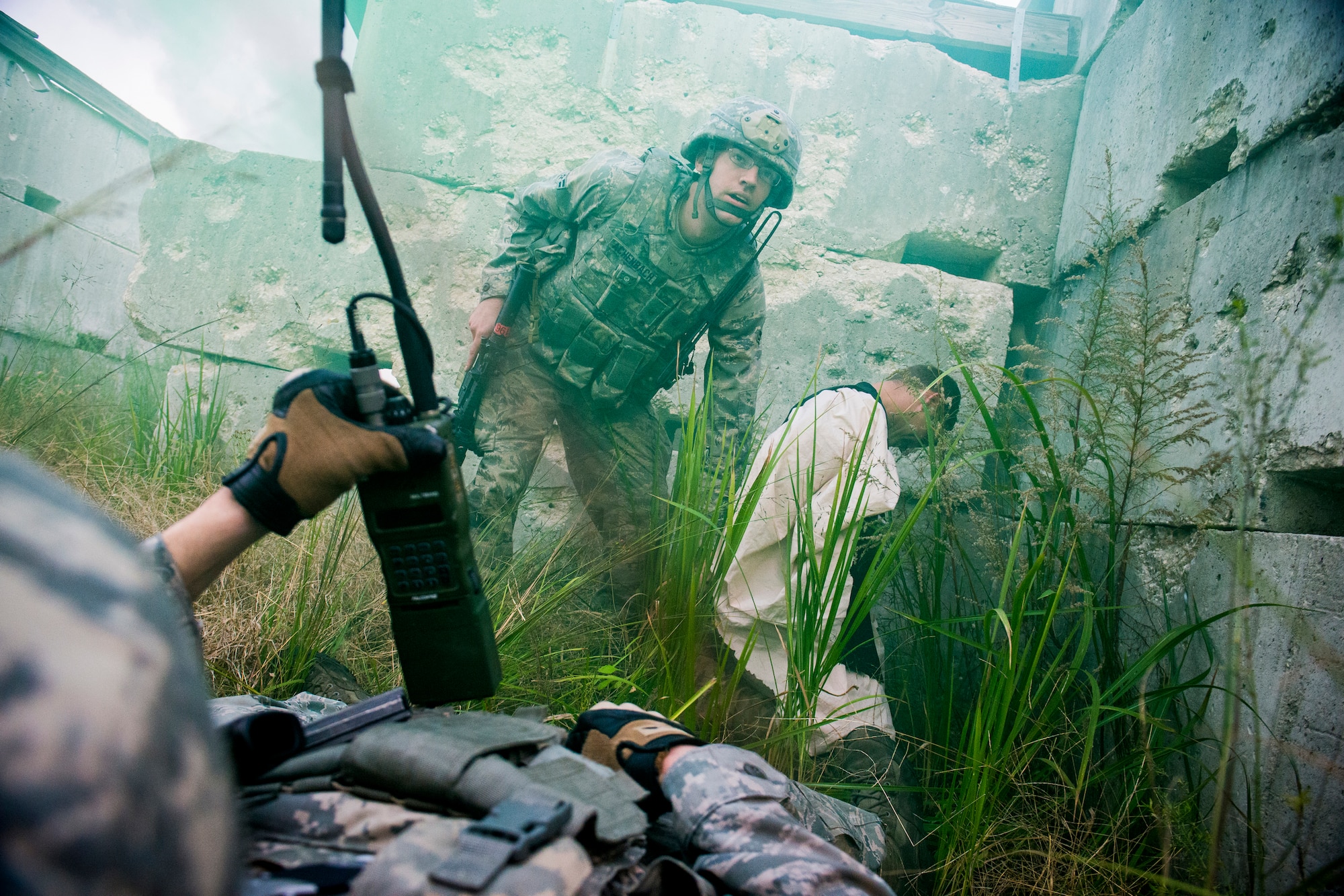 U.S. Air Force Airman 1st Class Theodore Achenbach, 823d Base Defense Squadron fire team member, protects a captured target during a training mission at Avon Park Air Force Range, Fla., Dec. 13, 2012. Achenbach and his team engaged in a five-minute fire fight with opposing forces and later received additional support from 38th Rescue Squadron pararescuemen. (U.S. Air Force photo by Staff Sgt. Jamal D. Sutter/Released)