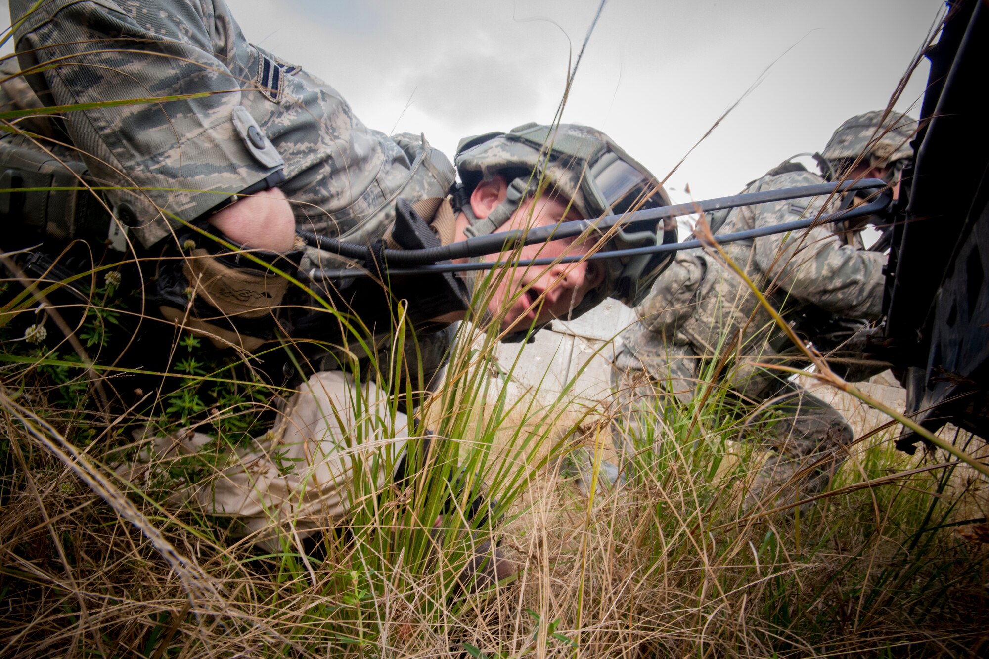 U.S. Air Force Airman 1st Class Kyle McNamara, 823d Base Defense Squadron fire team member, takes cover after being ambushed during a training mission at Avon Park Air Force Range, Fla., Dec. 13, 2012. McNamara and his team were in the midst of capturing a target when they took fire from opposing forces. (U.S. Air Force photo by Staff Sgt. Jamal D. Sutter/Released)  