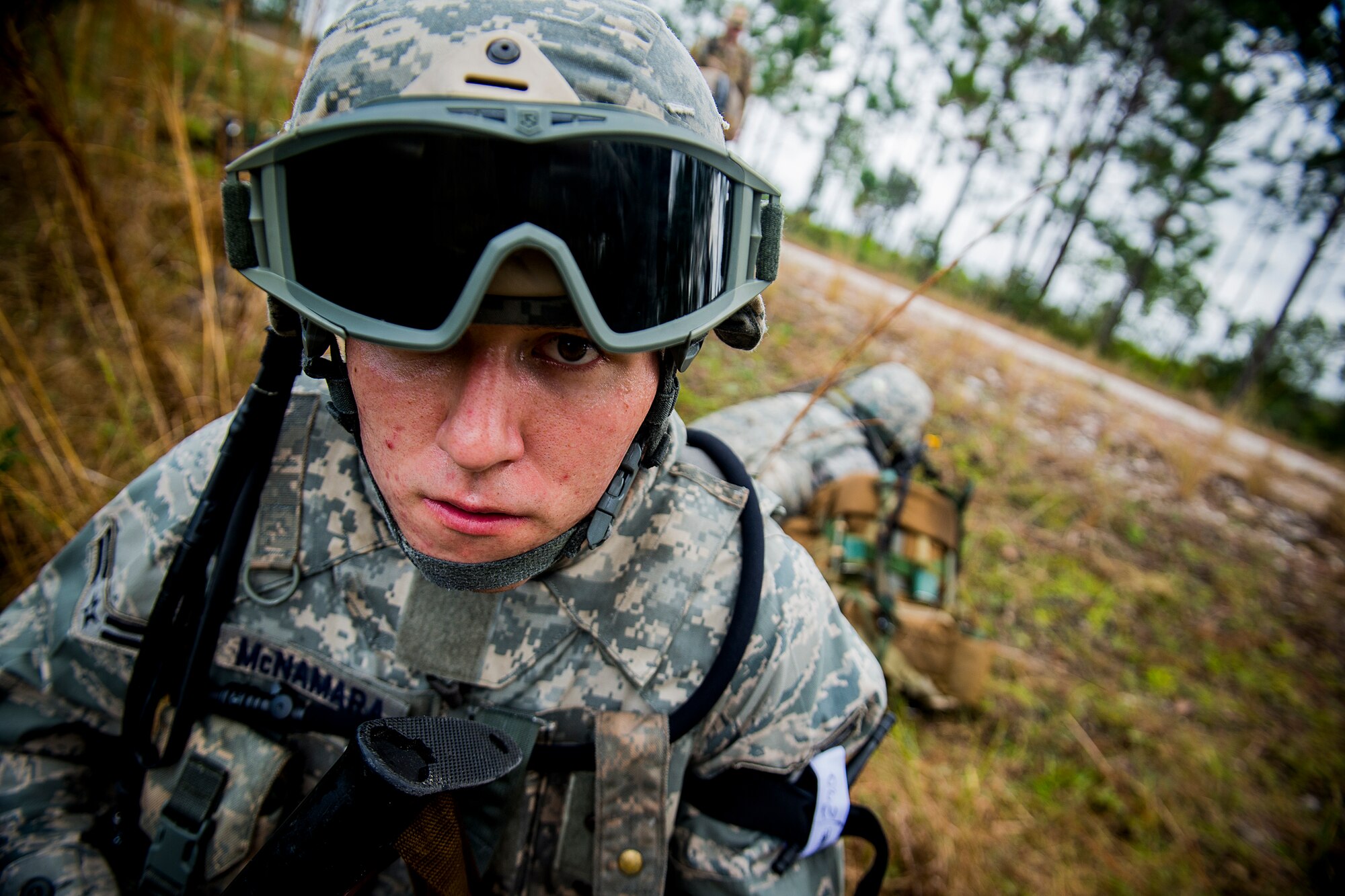 U.S. Air Force Airman 1st Class Kyle McNamara, 823d Base Defense Squadron fire team member, performs perimeter cover after a fire fight during a training mission at Avon Park Air Force Range, Fla., Dec. 12, 2012. The 823d BDS Airmen trained with 38th Rescue Squadron pararescuemen and combat rescue officers to familiarize themselves with each other’s ways of operating in combat situations. (U.S. Air Force photo by Staff Sgt. Jamal D. Sutter/Released) 