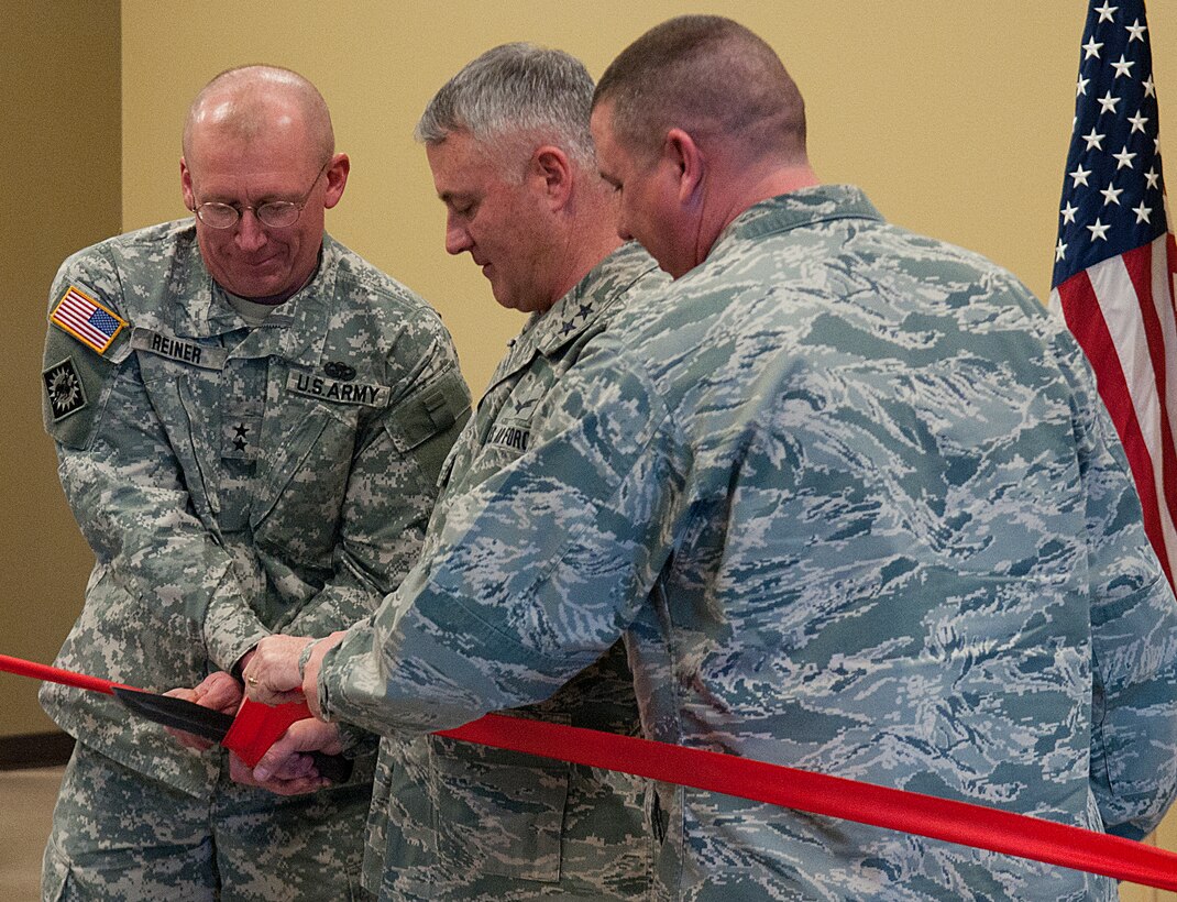 Army Maj. Gen. Luke Reiner, Wyoming National Guard adjutant general; Maj. Gen. Michael Carey, 20th Air Force commander; and Maj. Jay Parson, 620th Ground Combat Training Squadron commander, cut a ceremonial ribbon with a dagger at a ceremony for the Nuclear Security Tactics Training Center Dec. 13, in Guernsey, Wyo. The new center will be used by the 620th GCTS to train 20th AF security forces personnel in the protection of nuclear assets in the missile fields and while transporting them. (U.S. Air Force photo by R.J. Oriez)
