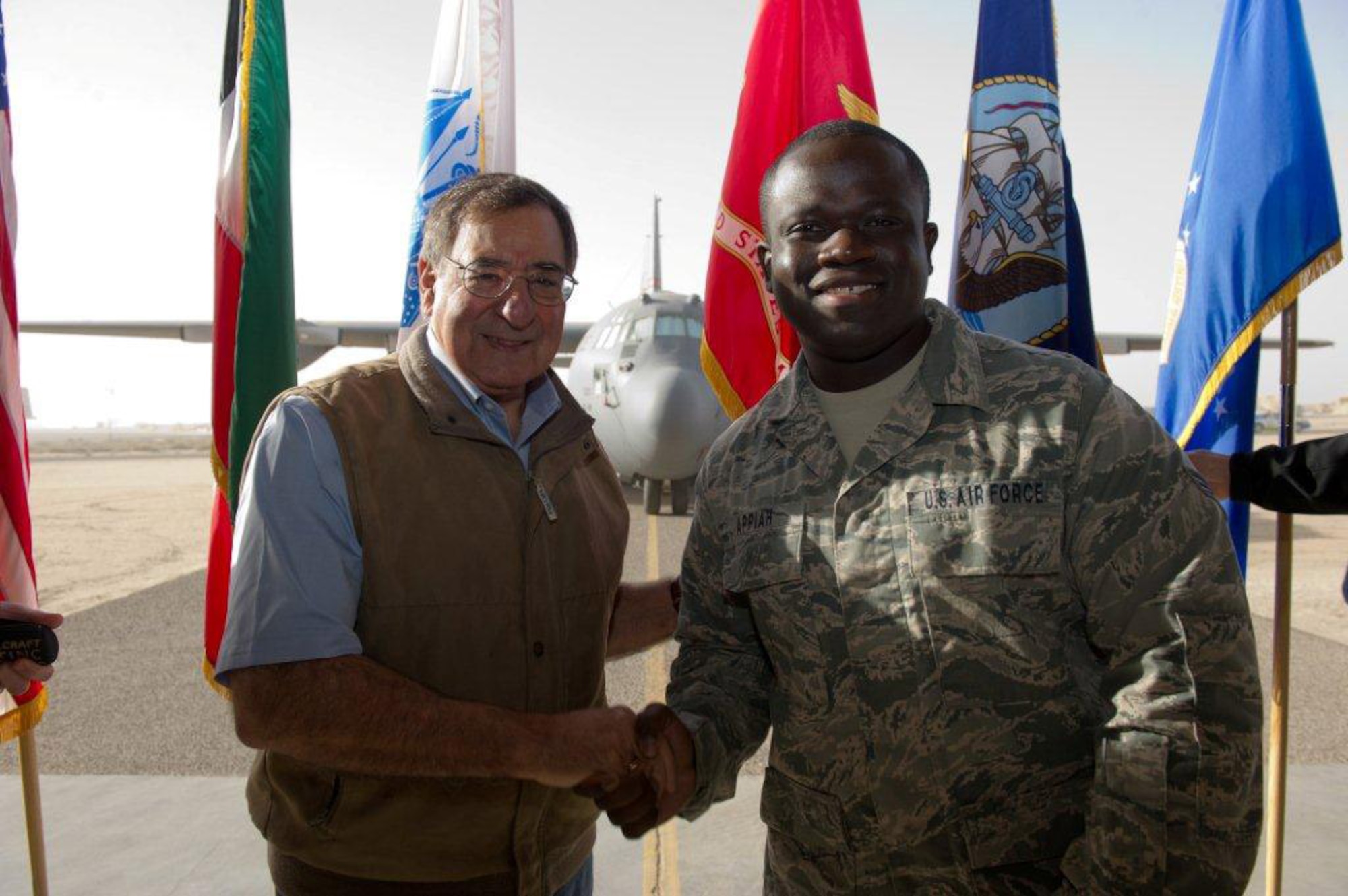 Senior Airman Derrick Appiah, 512th Force Support Squadron, meets Secretary of Defense Leon E. Panetta Dec. 12, 2012, while deployed to the 386th Air Expeditionary Wing, Southwest Asia. The actions of Appiah, who's on the Personnel Support for Contingency Operations team, made it possible for 20 deployed Airmen to make it home to the United States in time for Christmas. (DoD photo/Erin A. Kirk-Cuomo)