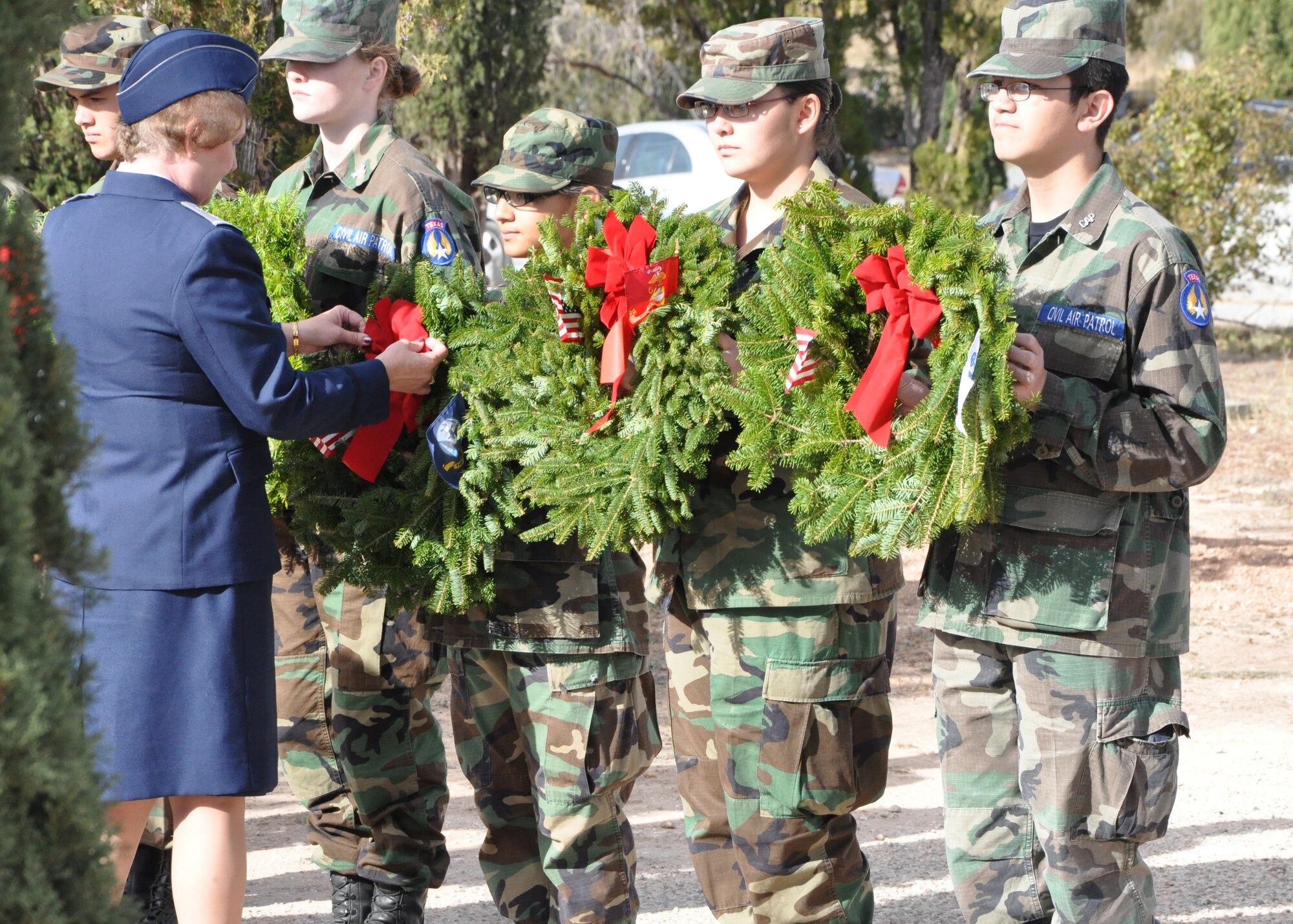 SAN ANGELO, Texas – Members of San Angelo Composite Squadron Civil Air Patrol have the ribbons on their wreaths touched up for Wreaths Across America at the Belvedere Cemetery Dec. 15. Wreaths Across America is an event to honor deceased service members and their families. (U.S. Air Force photo/ 1st Lt. Leanne Hedgepeth)