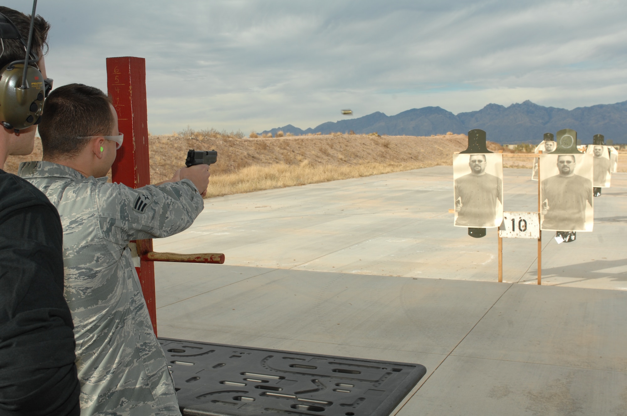 U.S. Air Force Senior Airmen Cody Vandermartin, 355th Comptroller Squadron,
shoots the SIG Sauer M11 handgun at the shooting range on Davis-Monthan Air
Force Base, Ariz. Dec. 18. Select Airmen from the base were able to
experience new weapons and shooting techniques.  (U.S. Air Force photo by 
Senior Airman Michael Washburn/Released)