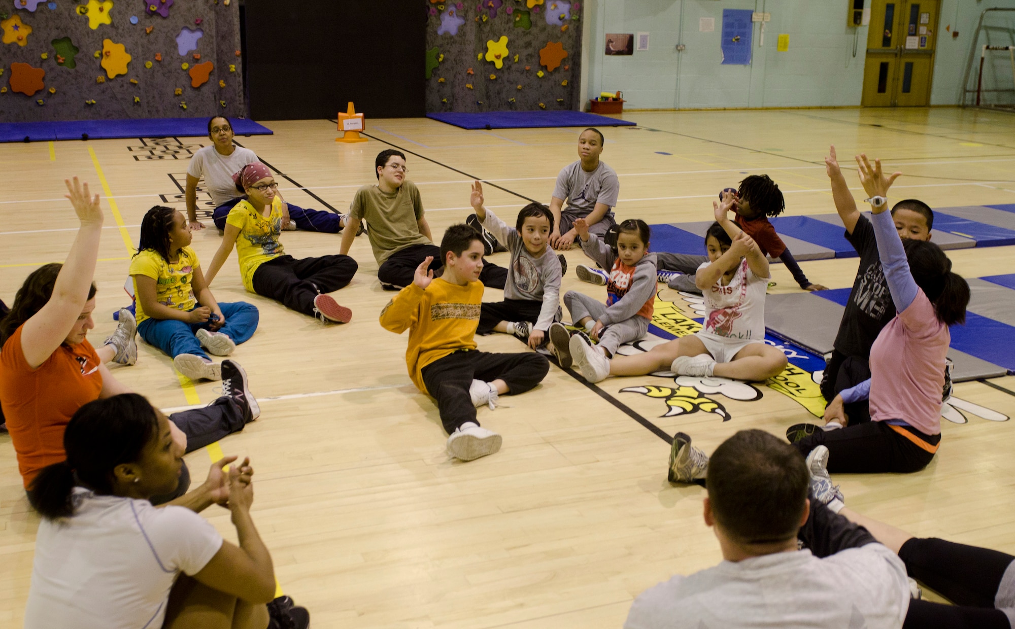 ROYAL AIR FORCE LAKENHEATH, England - The RAF Lakenheath Health and Wellness Center staff talk with children and volunteers after a Kids on the Move Class Dec. 13, 2012. KOTM is a free program intended to help children become more active and change their approach to exercise. The program is offered year-round and is open to children ages 4 - 12. Children older than 12 are welcome to participate as volunteers, helpers or team leaders. (U.S. Air Force photo Staff Sgt. Stephen Linch)