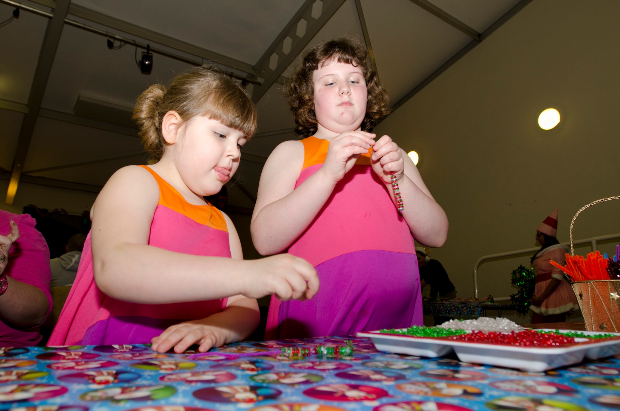 MILDENHALL, England - Katie (left), 6, and Jazmine, 8, work on Christmas crafts during the 48th Equipment Maintenance Squadron Annual Christmas Party, which was held for U.K. children at the Jubilee Center Dec. 17, 2012. The event, which 48th EMS Airmen have been putting on for 15 years, maintains traditions stemming from World War II when Americans would hold parties and give gifts to local children. (U.S. Air Force photo by Staff Sgt. Stephen Linch)