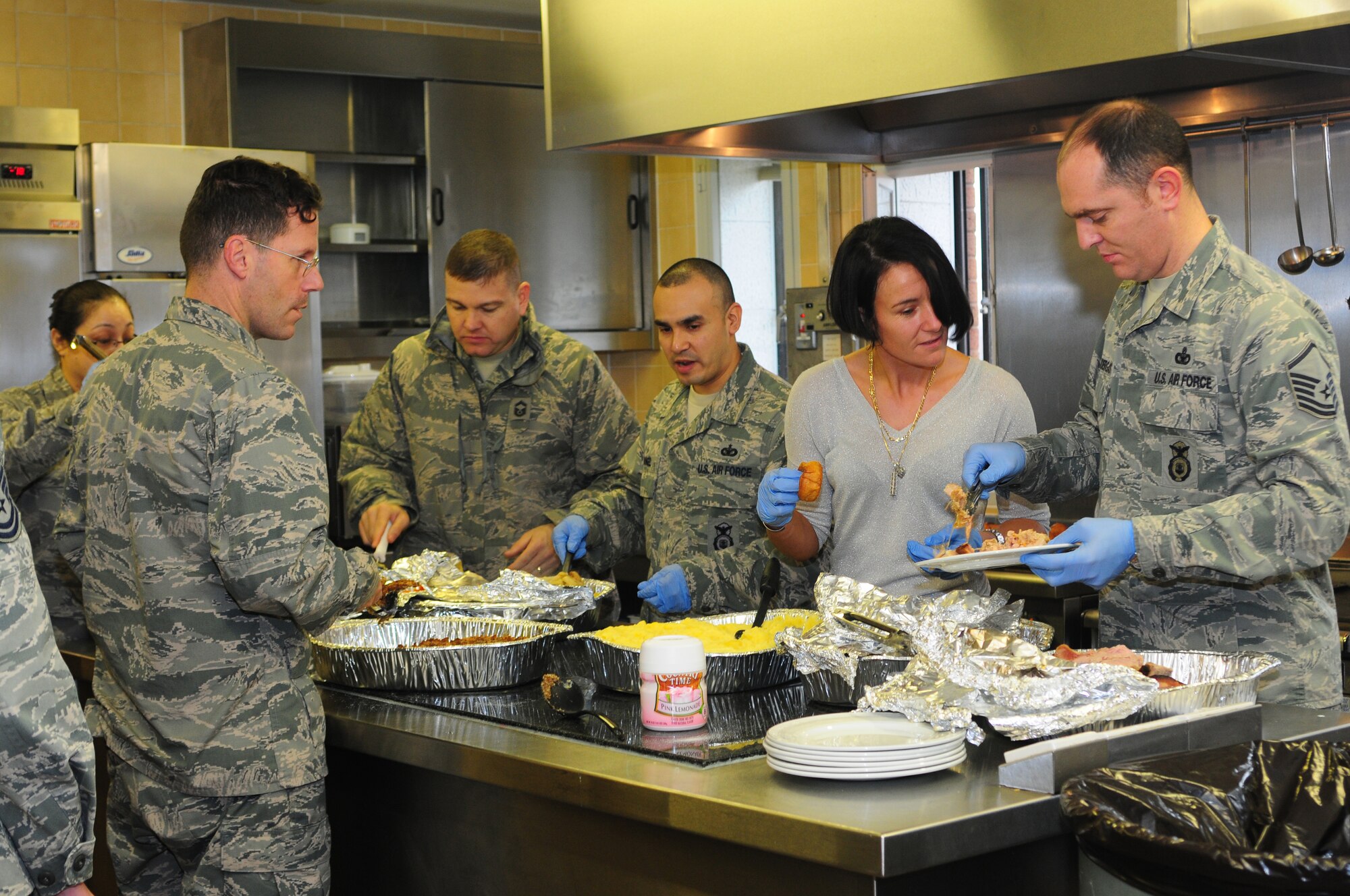 ROYAL AIR FORCE LAKENHEATH, England – Members of the 48th Fighter Wing prepare food for a Christmas lunch hosted by the 48th Security Forces Squadron Dec. 19, 2012. More than 40 members of the local community attended the luncheon which included games, prizes and holiday gifts donated by Liberty Wing Airmen. (U.S. Air Force photo by Airman 1st Class Cory D. Payne)