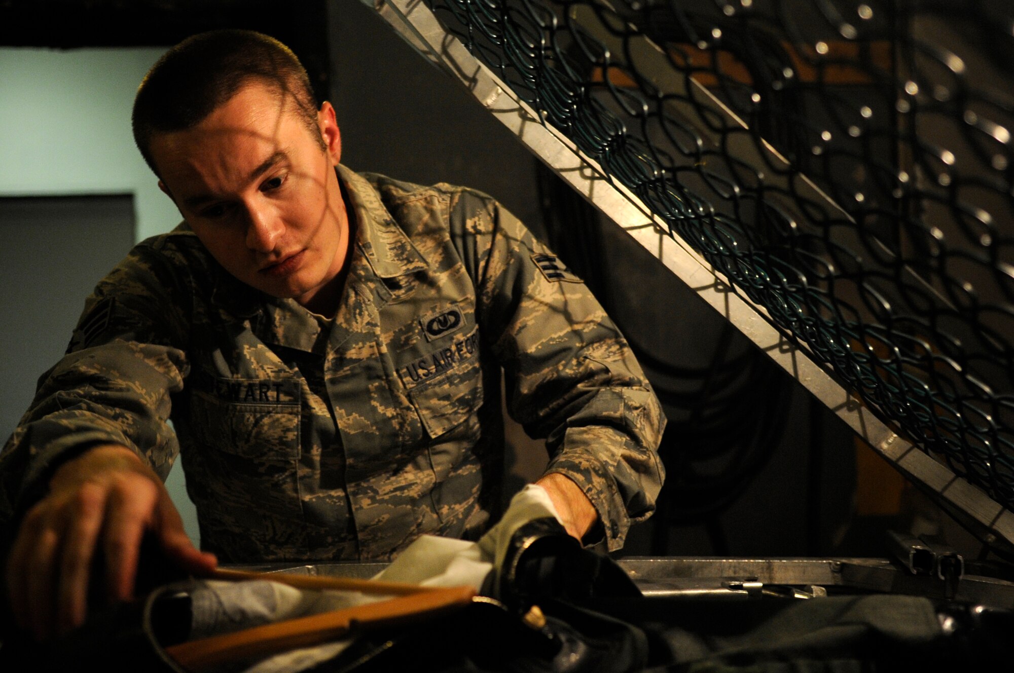Senior Airman Joshua Stewart, 8th Operations Support Squadron aircrew flight equipment technician, turns an anti-exposure suit inside out before water testing it Dec. 11, 2012, at Kunsan Air Base, Republic of Korea. The many detailed parts of the suit, including wrist seals and zippers, make thorough testing by the AFE technicians vital to ensuring the pilot’s safety if he must eject over water. (U.S. Air Force photo by Senior Airman Brigitte N. Brantley/Released)