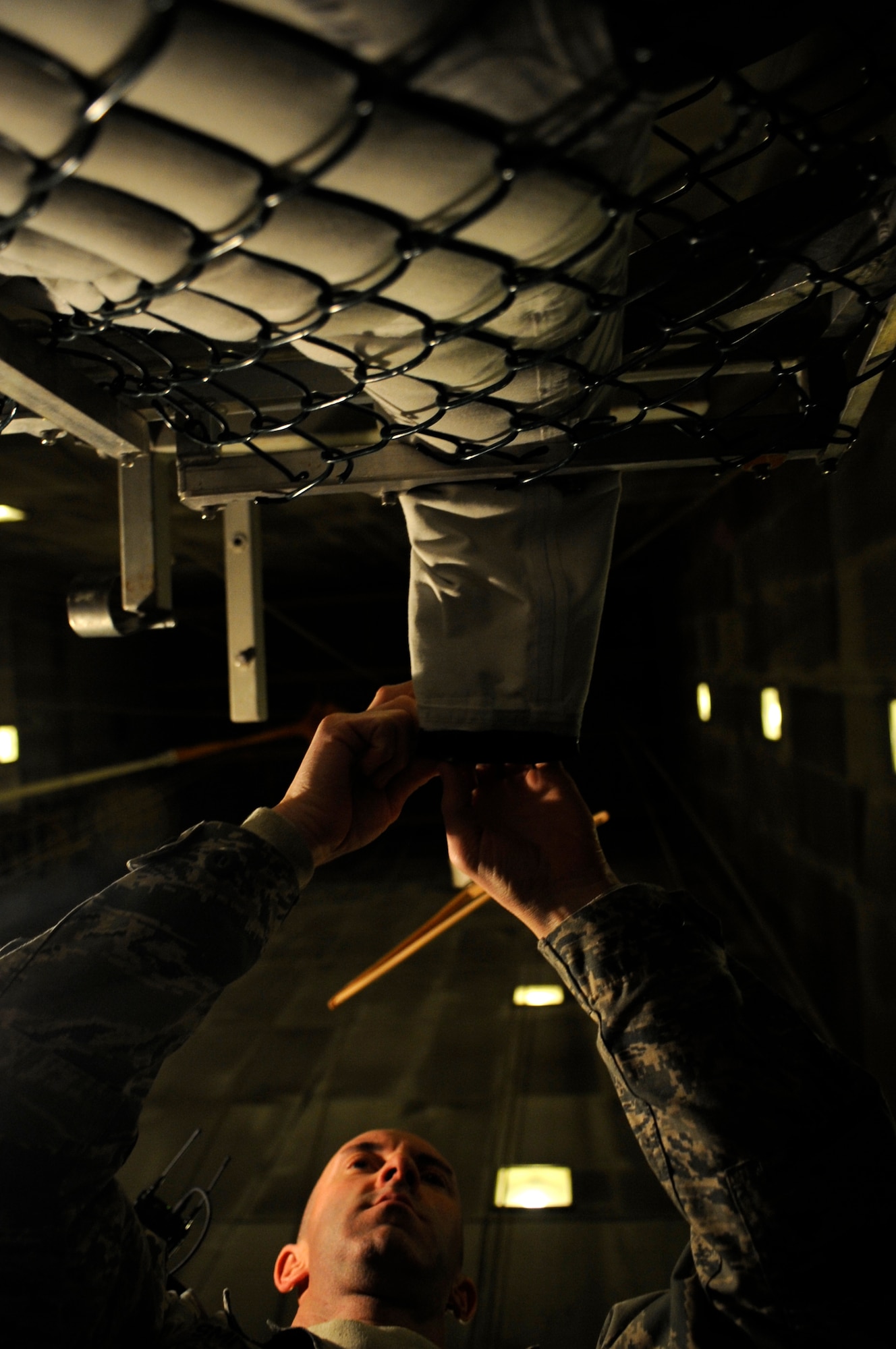 Staff Sgt. Joshua Smith, 8th Operations Support Squadron aircrew flight equipment assistant NCO in charge, rolls down the wrist seam of an anti-exposure suit Dec. 11, 2012, at Kunsan Air Base, Republic of Korea. From waterproofing pilots’ suits to ensuring their parachutes are properly packed, AFE technicians have an important role in pilots’ safety. (U.S. Air Force photo by Senior Airman Brigitte N. Brantley/Released)