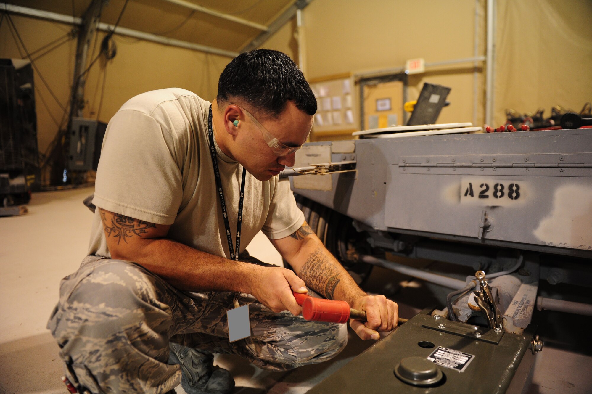 SOUTHWEST ASIA -- Staff Sgt. Jeffrey Cook, 379th Expeditionary Maintenance Squadron Munitions Support Equipment shop, tightens the bolts on a lighter tow bar, replacing the current two-person lift tow bar, during a refit of an ammo trailer Dec. 19. The lighter tow-bar will make it easier for the munitions technicians to hook up the ammo trailer, speeding up operations. (U.S. Air Force photo/ Master Sgt Brendan Kavanaugh)
