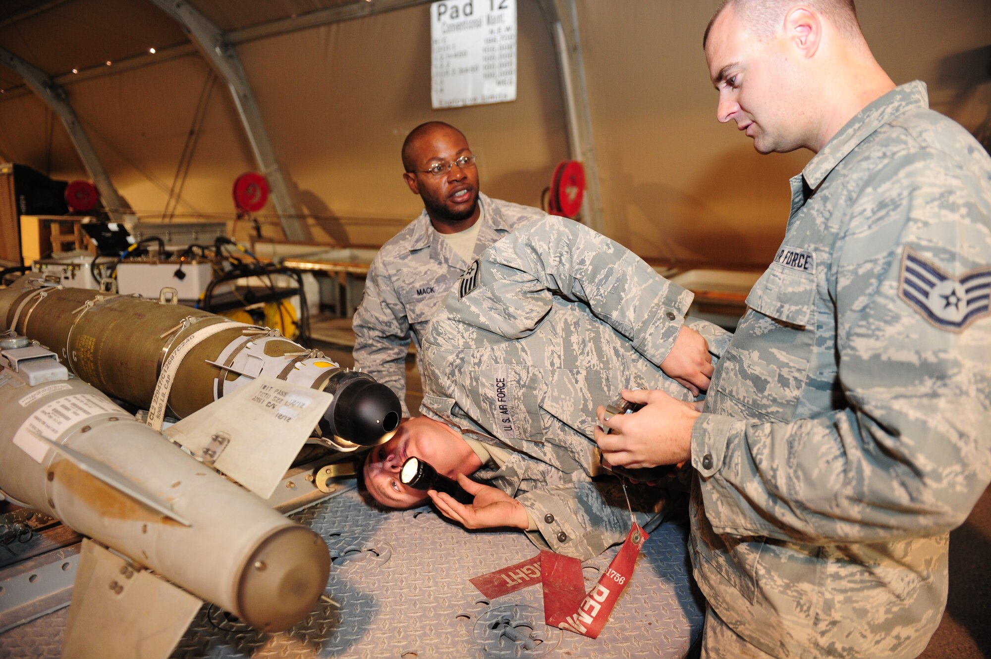 SOUTHWEST ASIA -- Staff Sgt. Joshua Harmer, 379th Expeditionary Maintenance Squadron Conventional Munitions shop, inpsects the nosecone of a GBU-54 Laser Joint Direct Attack Munition recently downloaded from a B-1B Lancer assigned to the 379th Air Expeditionary Wing Dec. 19. If the munitions aren't utilized during a mission, they are returned, inspected, software packages upgraded and stored for later use. (U.S. Air Force photo/Master Sgt. Brendan Kavanaugh)
