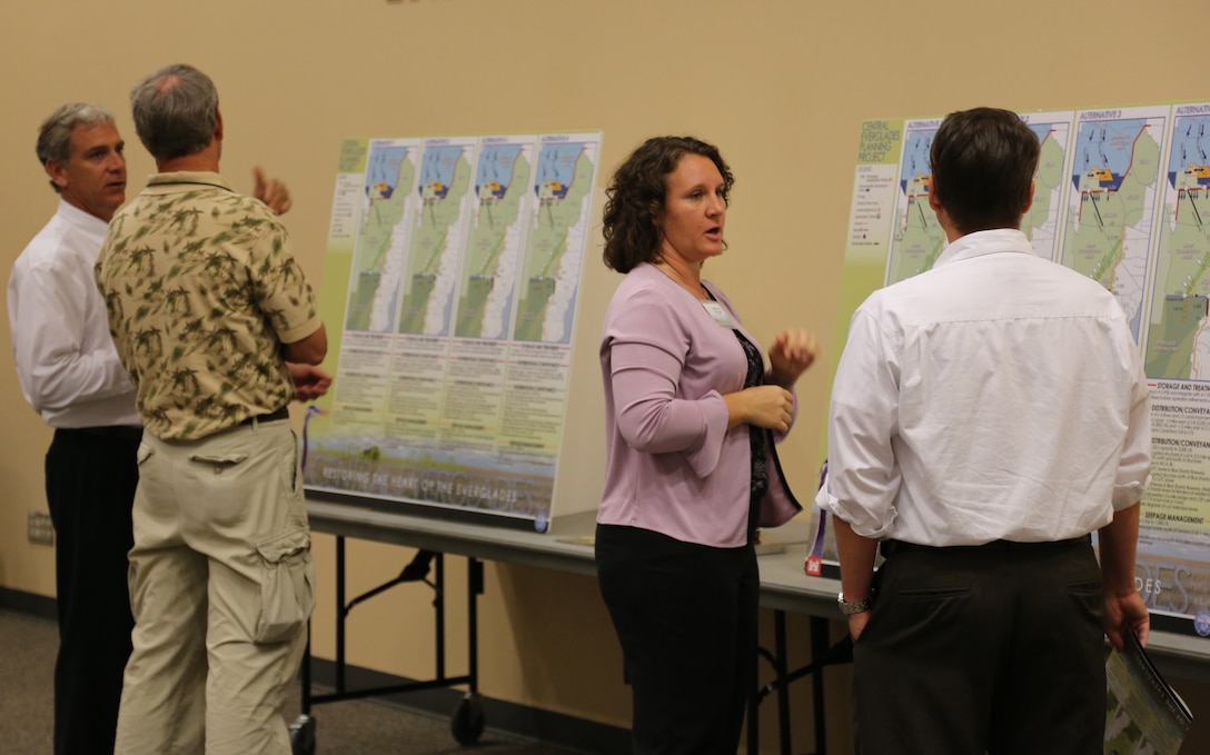Matt Morrison (left), South Florida Water Management District project manager for the Central Everglades Planning Project (CEPP) and Gretchen Ehlinger(second from right), U.S. Army Corps of Engineers environmental lead for CEPP, explain the proposed final array of alternatives for CEPP at the Dec. 13 public meeting in Stuart, Fla. An open house was held at each of the five public meetings conducted throughout south Florida Dec. 10-13 and Dec. 18.