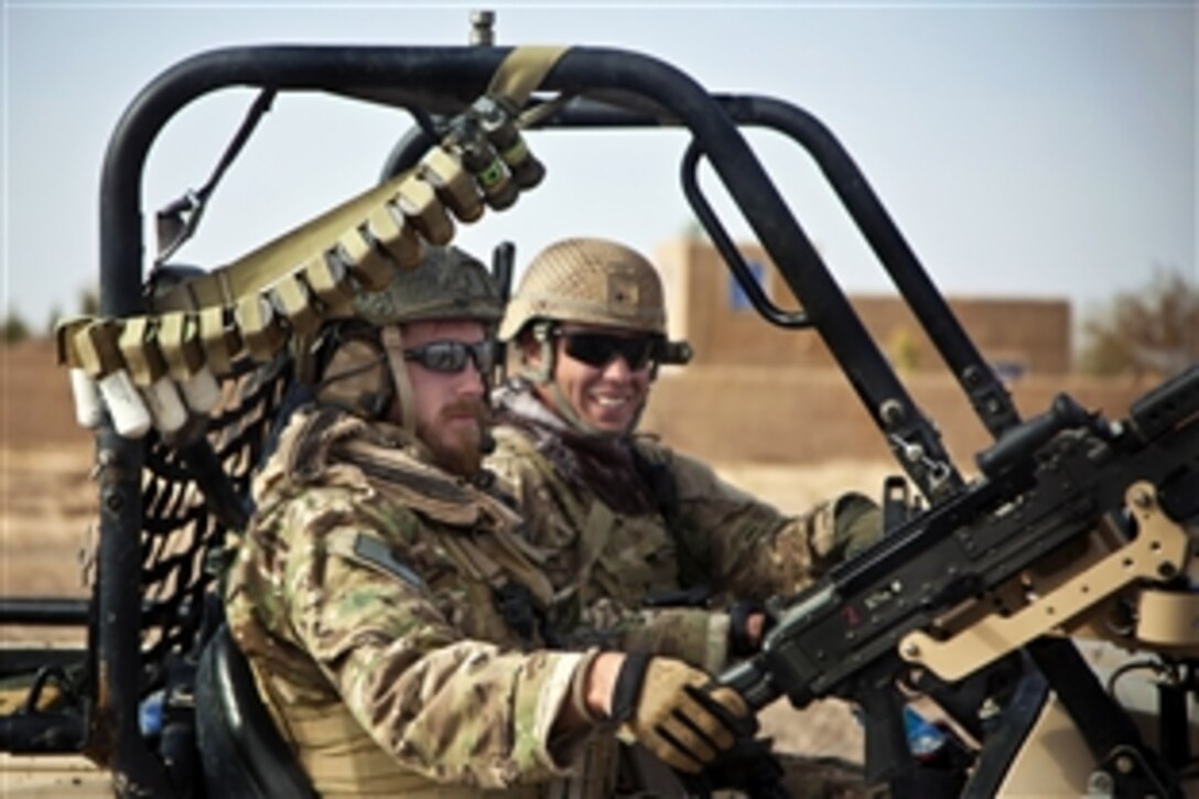 Coalition service members ride in a light-tactical all-terrain vehicle during a presence patrol in Afghanistan's Farah province, Dec. 16, 2012.