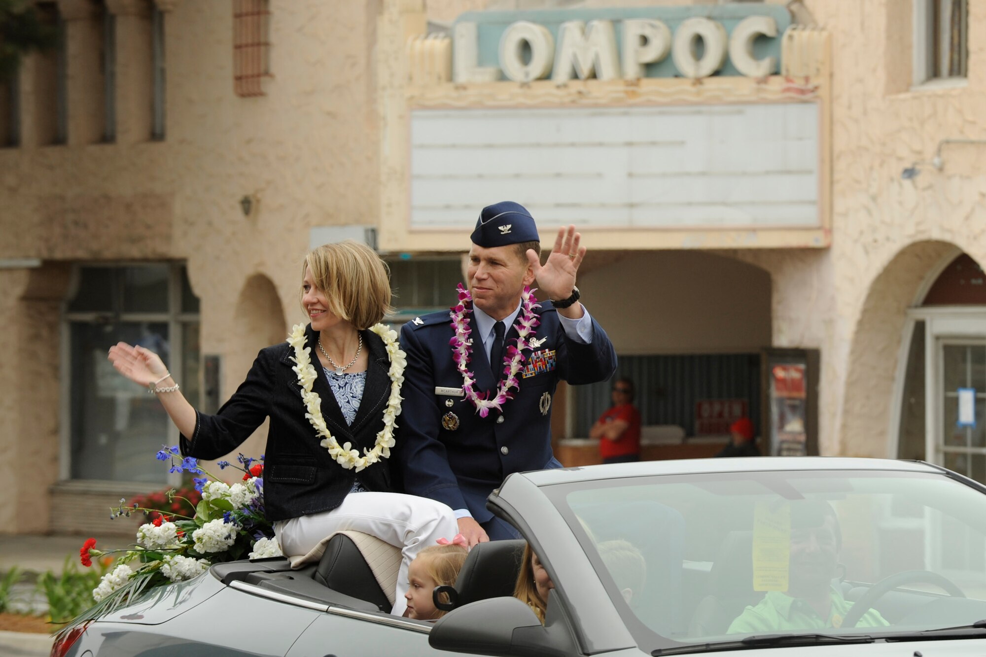 VANDENBERG AIR FORCE BASE, Calif. -- Col. Brent McArther, 30th Space Wing vice commander, and his family wave to parade watchers during the city of Lompoc's 60th Annual Flower Festival Saturday, June 23, 2012. The parade is part of a five day celebration of Lompoc’s flower fields and culture. (U.S. Air Force photo/Staff Sgt. Levi Riendeau)