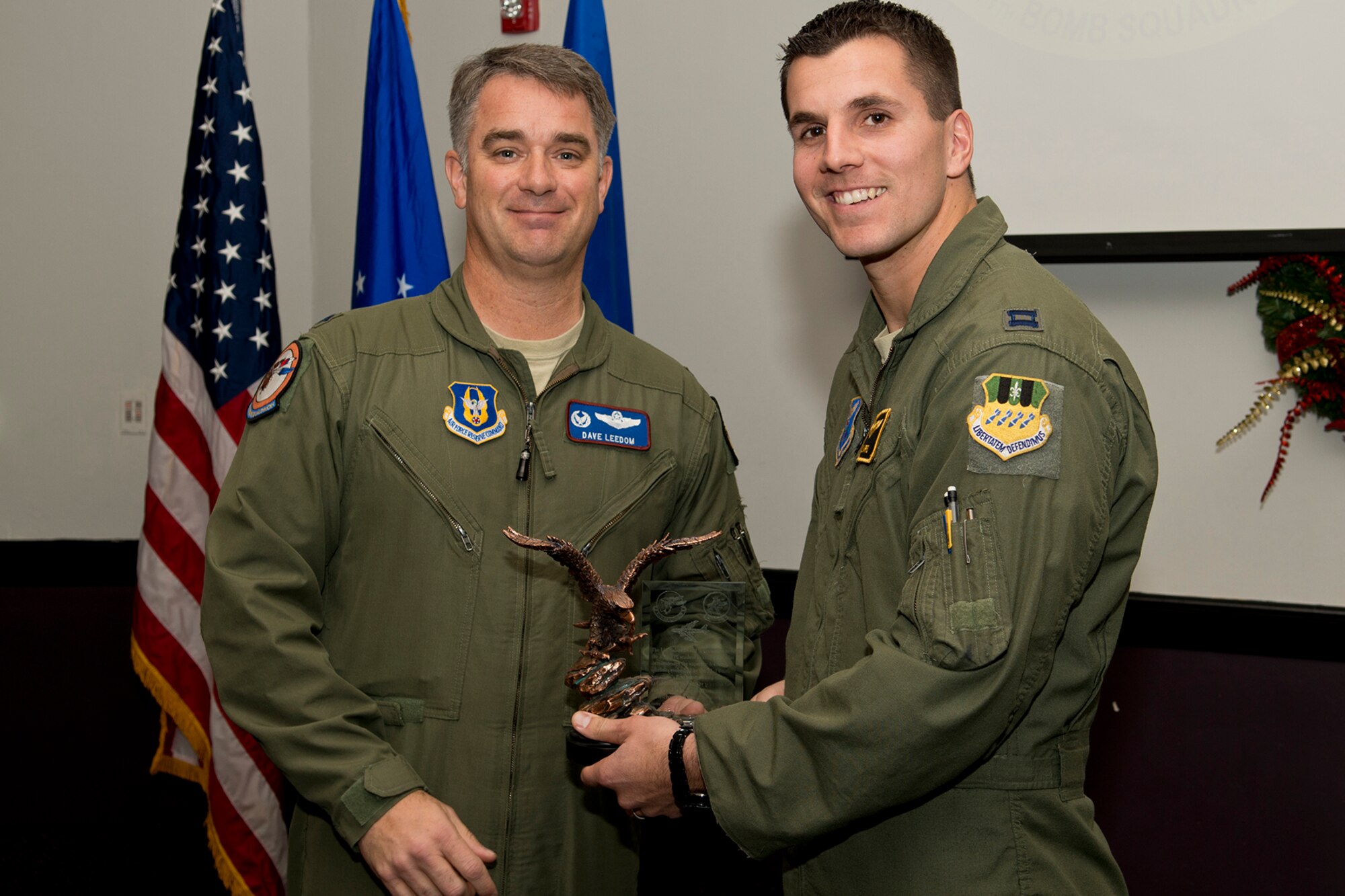 U.S. Air Force Lt. Col. David Leedom, 93rd Bomb Squadron commander, presents the Lindell Mabus Leadership Award to Capt. William Harris during a B-52 Formal Training Unit Graduation ceremony, Dec. 21, 2012, Barksdale Air Force Base, La. The members of Class 12-03 selected fellow student Mastracchio for the award because of her exceptional leadership that was crucial to the class's graduation. (U.S. Air Force photo by Master Sgt. Greg Steele/Released)