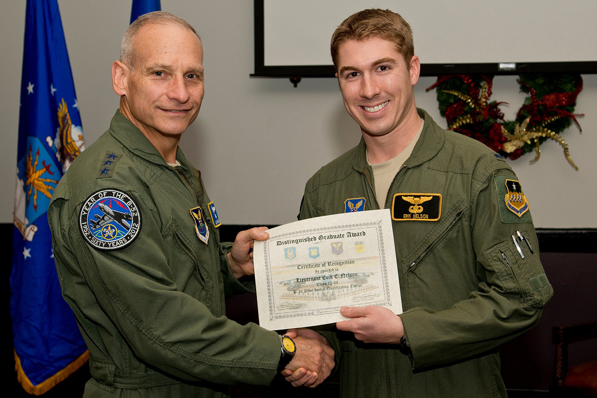 U.S. Air Force Lt. Gen. James Kowalski presents the Copilot Distinguished Graduate award to 1st Lt. Erik Nelson during a B-52 Formal Training Unit Graduation ceremony, Dec. 21, 2012, Barksdale Air Force Base, La. The Distinguished Graduate Award is a culmination of academic tests, flight evaluations, officership, attitude and professional bearing, and the winner is selected by having demonstrated training and performance that was consistently and clearly above their peers. (U.S. Air Force photo by Master Sgt. Greg Steele/Released)