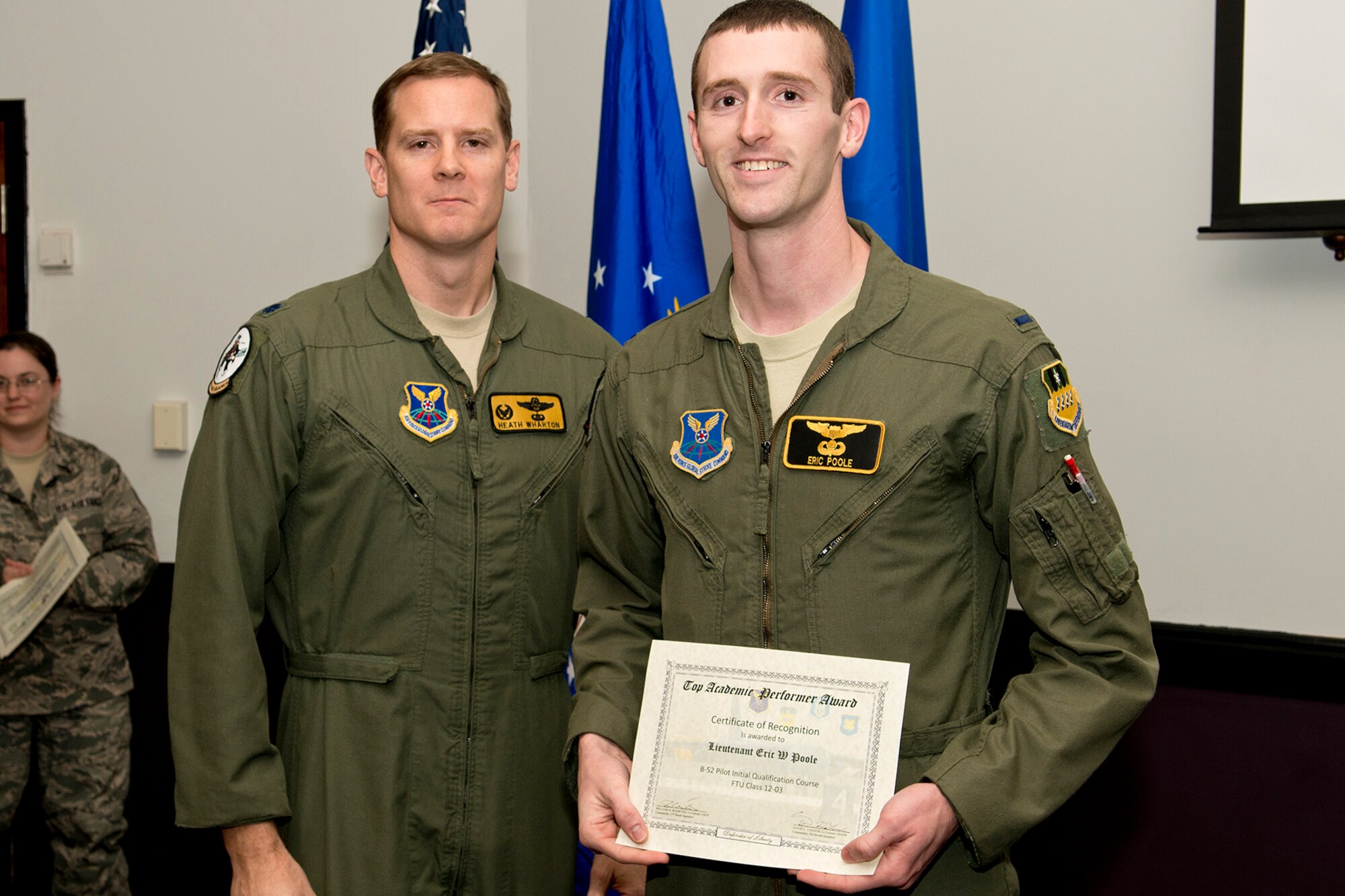 U.S. Air Force Lt. Col. William Wharton, 11th Bomb Squadron commander, presents the Copilot Outstanding Academic Performer award to 1st Lt. Eric Poole during a B-52 Formal Training Unit Graduation ceremony, Dec. 21, 2012, Barksdale Air Force Base, La. Poole achieved an overall academic average of 98.64 percent. (U.S. Air Force photo by Master Sgt. Greg Steele/Released)