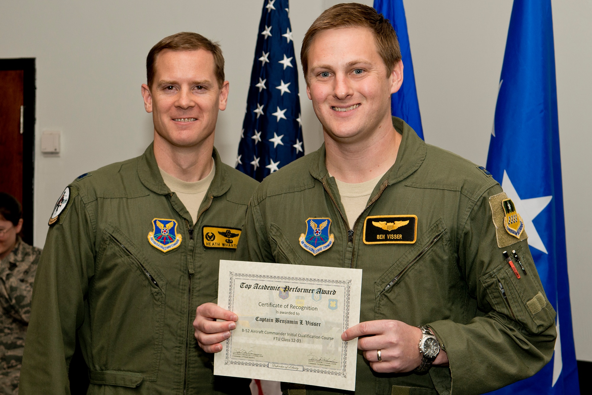U.S. Air Force Lt. Col. William Wharton, 11th Bomb Squadron commander, presents the Aircraft Commander Outstanding Academic Performer award to Capt. Benjamin Visser during a Formal Training Unit Graduation ceremony, Dec. 21, 2012, Barksdale Air Force Base, La. Visser achieved an overall academic average of 99 percent. (U.S. Air Force photo by Master Sgt. Greg Steele/Released)