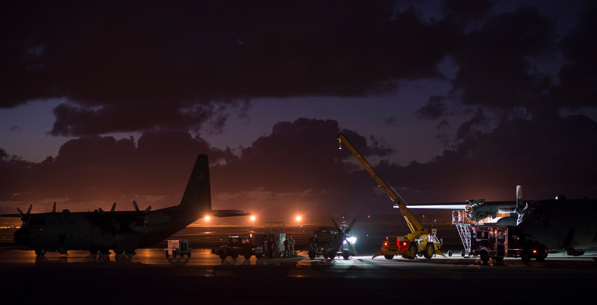 ANDERSEN AIR FORCE BASE, Guam -- Maintenance crews work through the night to repair a C-130 Hercules from Yokota Air Base, Japan, at Andersen Air Force Base, Guam, Dec. 11, 2012. Aircrews dropped approximately 120 boxes in more than 65 bundles over the course of 8 days to help more than 30,000 islanders inhabiting the remote islands in Micronesia. (U.S. Air Force photo by Tech. Sgt. Samuel Morse)