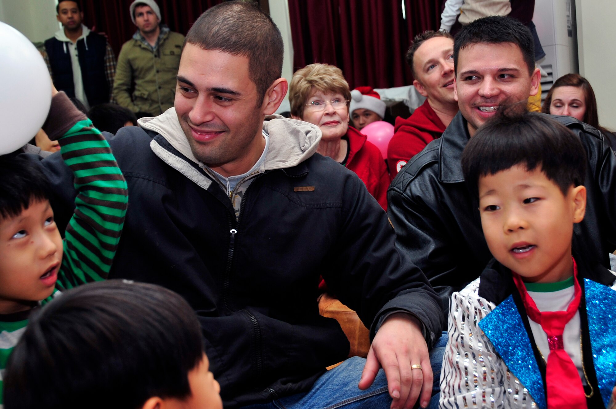 Osan Air Base community members play with Korean orphans Dec. 22, 2012. Team Osan gave back during the holidays through Operation Christmas Hope by ensuring children in local Korean orphanages received a little bit of cheer and a gift. (U.S. Air Force photo/Airman 1st Class Alexis Siekert)