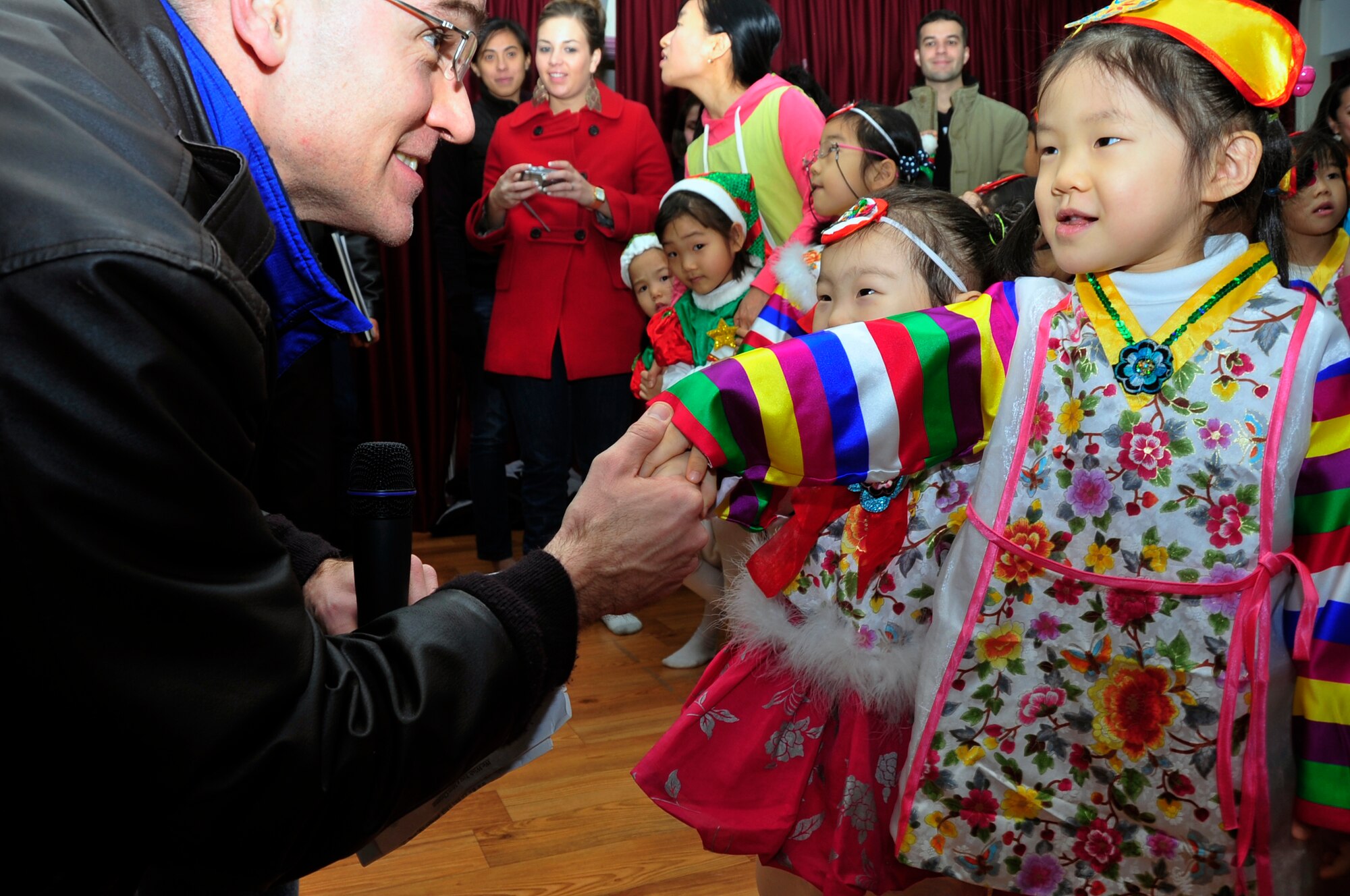 Chaplain (Capt.) Daniel Forman, 51st Fighter Wing chaplain, shakes hands with a Korean girl at a local orphanage Dec. 22, 2012. More than 600 volunteers visited 20 local orphanages as part of Operation Christmas Hope, an event focused on the spirit of giving. (U.S. Air Force photo/Airman 1st Class Alexis Siekert)