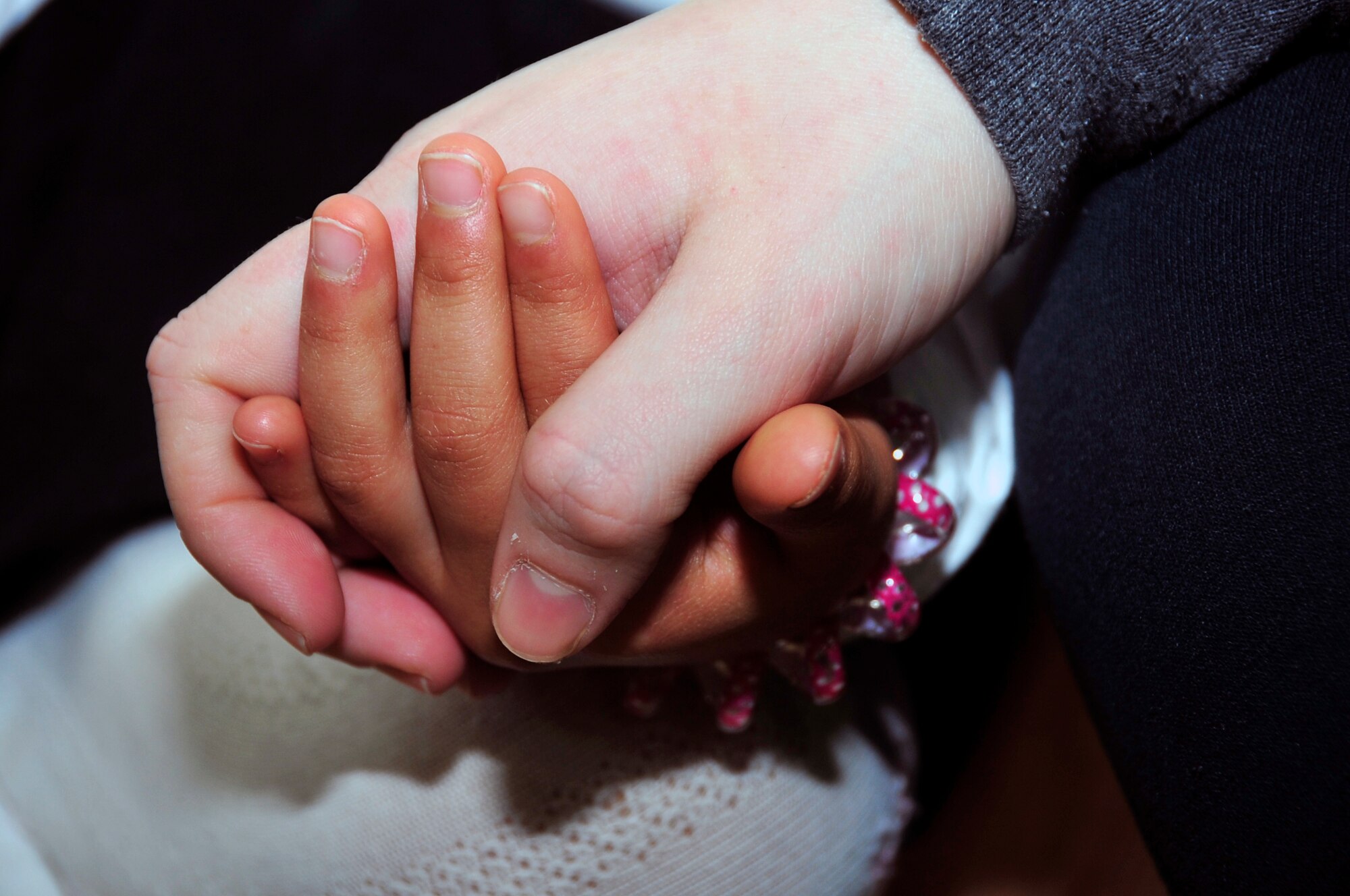 An American service member from Osan Air Base holds hands with a Korean orphan during a visit to an orphanage as part of Operation Christmas Hope Dec. 22, 2012. More than 600 volunteers from the base community came together to deliver the gifts, sing Christmas carols and offer prayer at local Korean orphanages. (U.S. Air Force photo/Airman 1st Class Alexis Siekert)