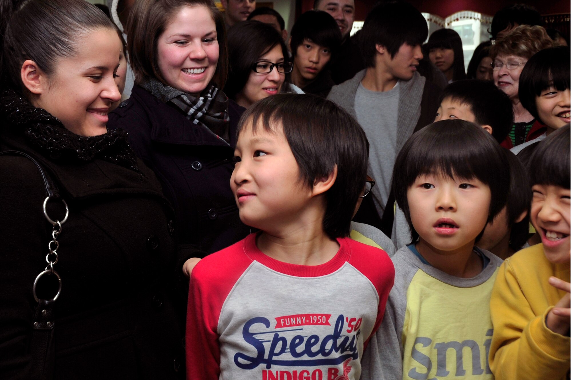 Osan Air Base community members sing Christmas carols with Korean children at an orphanage Dec. 22, 2012. More than 600 volunteers visited 20 local orphanages as part of Operation Christmas Hope, an event focused on the spirit of giving. (U.S. Air Force photo/Airman 1st Class Alexis Siekert)