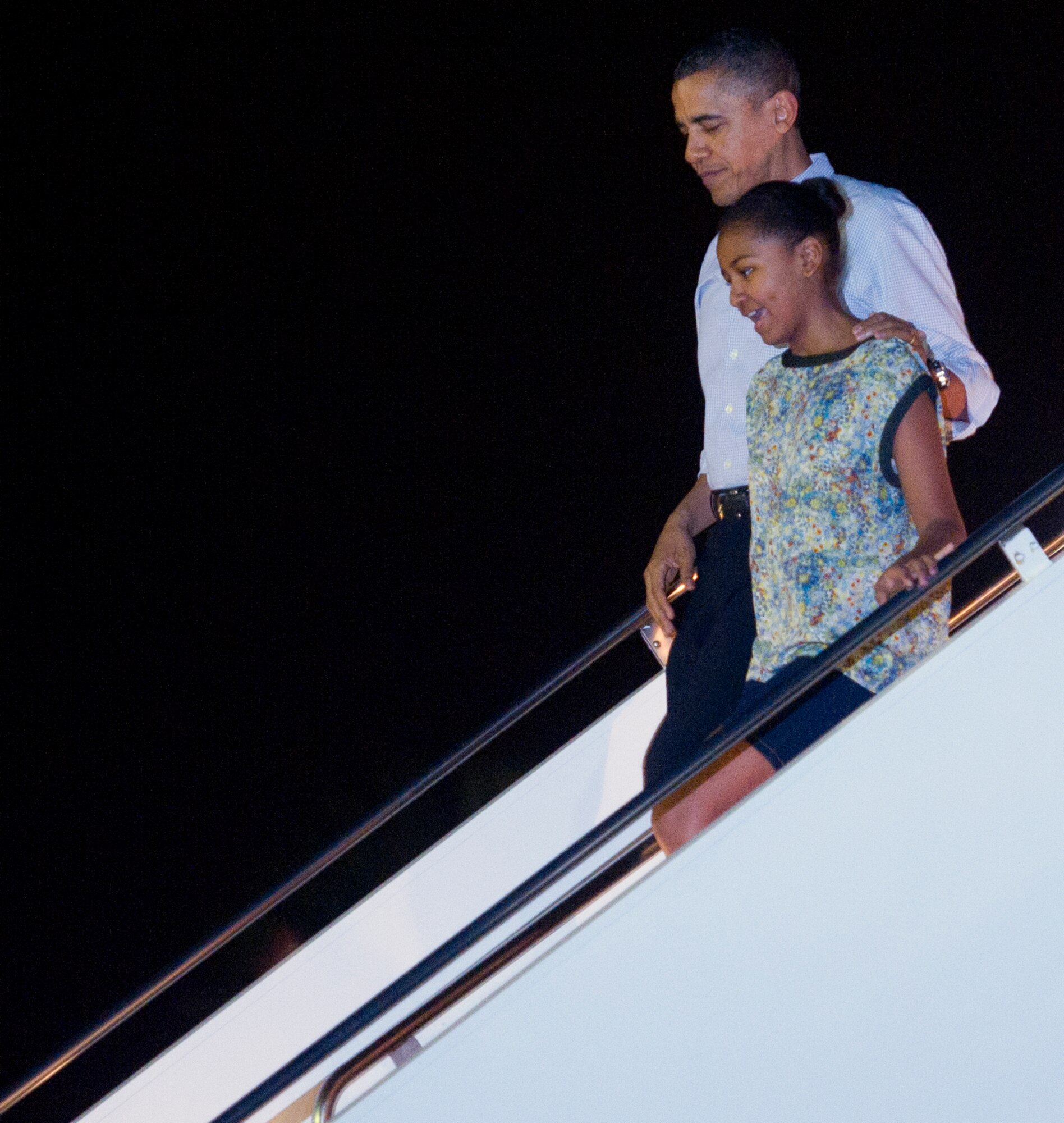 President Barack Obama and his daughter, Sasha, disembark Air Force One upon arrival at Joint Base Pearl Harbor-Hickam, Hawaii, Dec. 22. The President and his family are expected to vacation on the island of Oahu through the holiday. (U.S. Air Force photo/Staff Sgt. Nathan Allen)