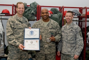 Col. Corey Martin, 376th Air Expeditionary Wing commander, and Chief Master Sgt. Bryan Creager, 376th Air Expeditionary Wing command chief notified Tech Sgt. Darnell Walls, 376th Expeditionary Civil Engineer Squadron Assistant chief of operations, of his promotion to the rank of master sergeant at Transit Center at Manas, Kyrgyzstan, Dec. 21, 2012. Wells received his promotion through the Stripes for Exceptional Performers program. Wells is currently deployed from Charleston Air Force Base, and is a native of Chicago, Ill. (U.S. Air Force / Staff Sgt. Stephanie Rubi) 