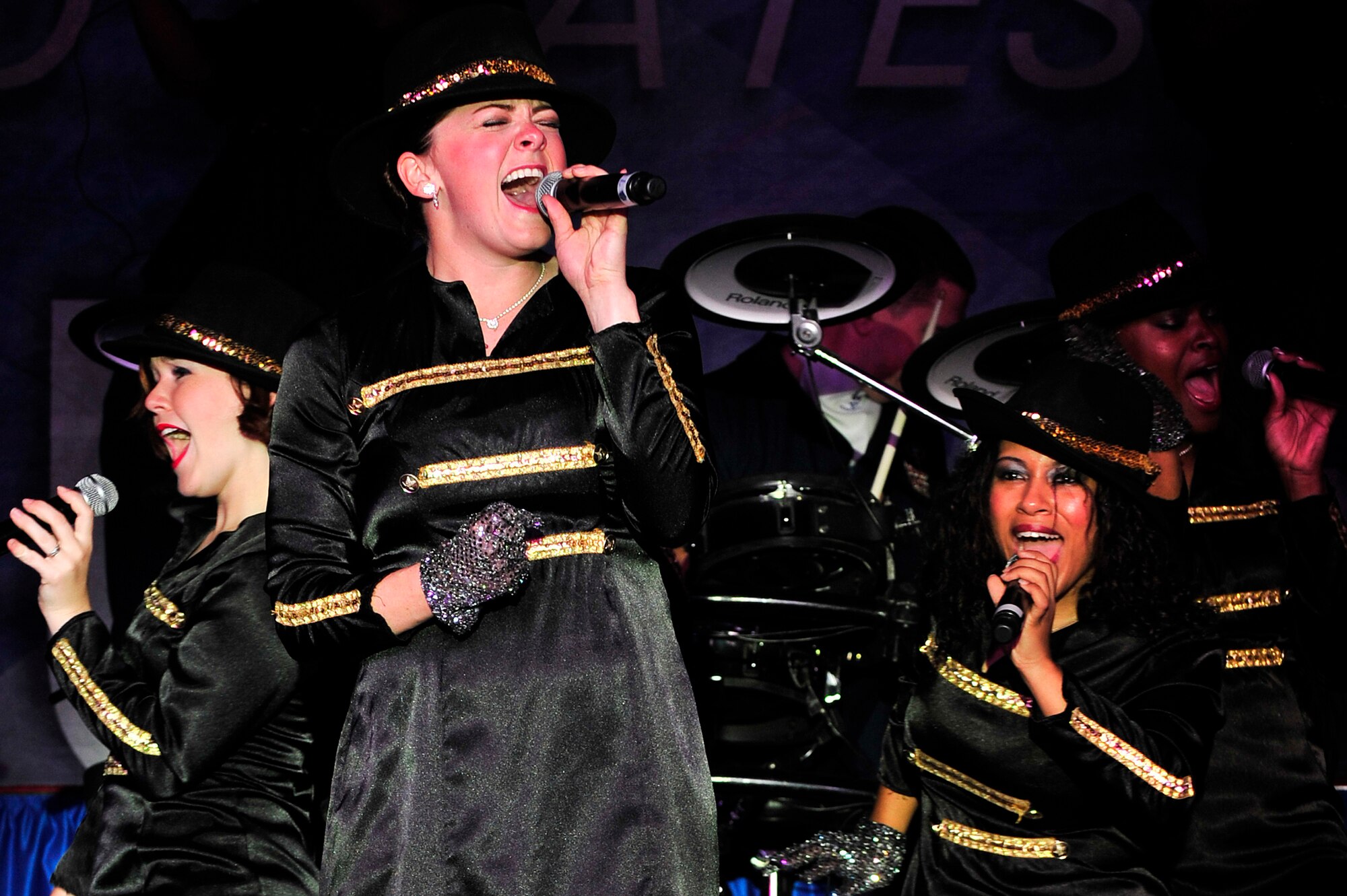 SOUTHWEST ASIA -- Tops In Blue vocalist, U.S. Air Force Capt. Ashley Elmore, performs for the men and women of the 380th Air Expeditionary Wing during a Michael Jackson tribute Dec. 20, 2012. During their 10-month 2012 tour, "Listen," Tops In Blue will travel throughout the United States and more than 20 countries, to include a stop at every Air Force base in the area of responsibility. (U.S. Air Force photo/Tech. Sgt. Christina M. Styer) (RELEASED)