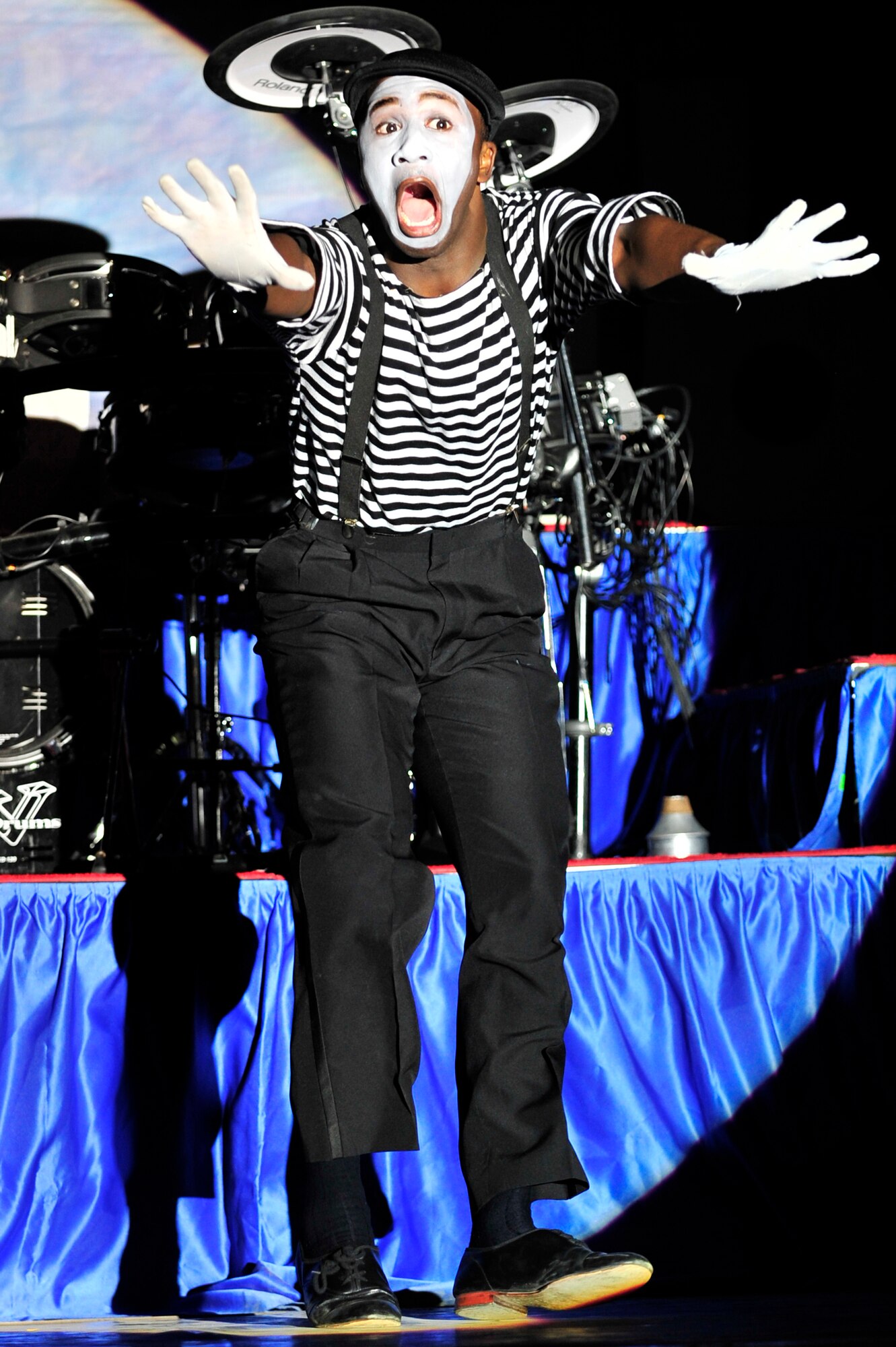 SOUTHWEST ASIA -- Tops In Blue vocalist, U.S. Air Force Airman 1st Class Jonathan Leak, performs a mime routine Dec. 20, 2012, during a performance at the 380th Air Expeditionary Wing. During their 2012 tour, "Listen," the group has performed more than 140 shows, including 14 performances in the area of responsibility for deployed members. (U.S. Air Force photo/Tech. Sgt. Christina M. Styer) (RELEASED)