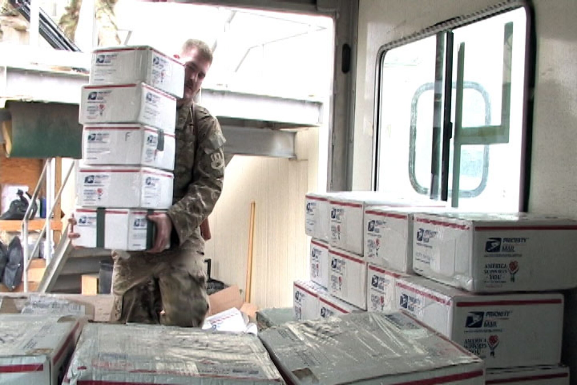 BAGRAM AIRFIELD, Afghanistan -- Senior Airman Ross Johnson, a loadmaster with the 774th Expeditionary Airlift Squadron, loads boxes of items sent from students in Worthington, Ohio, to be palletized for delivery at Bagram Airfield, Afghanistan, Dec. 13, 2012. The boxes will be airdropped into remote Combat Operations Bases throughout Afghanistan. (U.S. Air Force photo/Master Sgt. Jun Kim)
