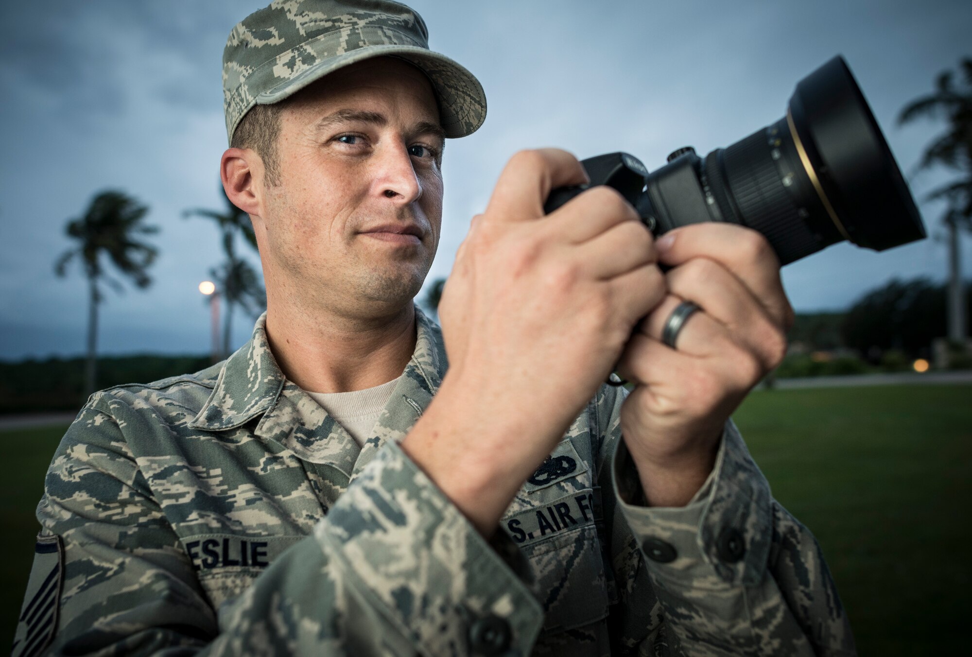 ANDERSEN AIR FORCE BASE, Guam -- Master Sgt. Cameron Leslie, 36th Wing career assistance advisor and independent photojournalist, holds a camera at Andersen Air Force Base, Guam, Dec. 13, 2012. Leslie traveled to Micronesia in 2011 to see Operation Christmas Drop from the perspective of the islanders. (U.S. Air Force photo by Tech. Sgt. Samuel Morse)
