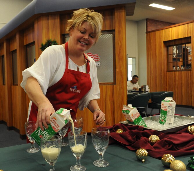 Candra Milohnic, wife of U.S. Air Force Col. Peter Milohnic, 18th Operations Group commander, pours egg nog for Airmen, Marines and Soldiers at the Marshal Dining Facility on Kadena Air Base, Japan, Dec. 25, 2012. Approximately 30 members of Kadena’s leadership and their families came to the annual Christmas meal to give back to the Airmen and wish them a happy holiday. (U.S. Air Force photo/Airman 1st Class Malia Jenkins)