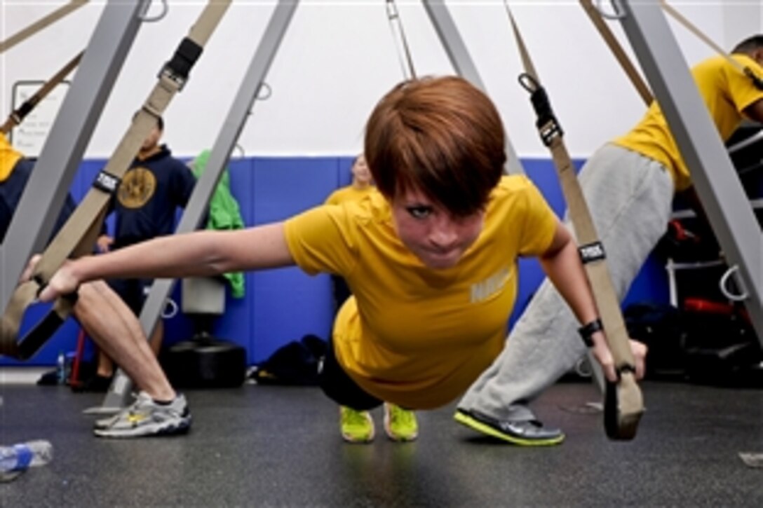 Navy Petty Officer 3rd Class Amber Ferguson participates in a suspension training class at the gym on Naval Station Everett in Everett, Wash., Dec. 18, 2012. Ferguson is an engineman assigned to the aircraft carrier USS Nimitz. Sailors who participated in the two-day class earned a certification to instruct resistance workouts aboard the ship. 

