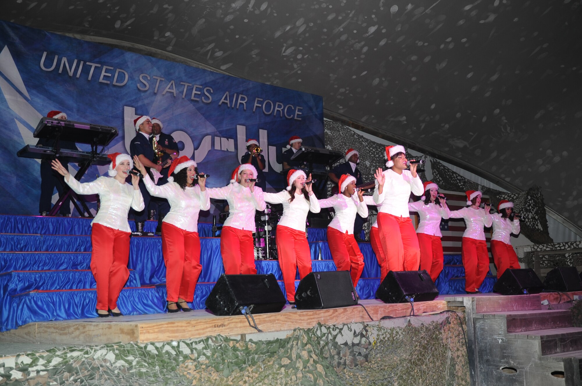 BAGRAM AIRFIELD, Afghanistan - Senior Airman Jessica Cunningham sings "All I Want for Christmas is You" during a performance by Tops in Blue here, Dec. 24, 2012. The troupe closed their two-hour performance with a medley of popular holiday songs and a visit from Santa Claus. (U.S. Air Force photo/Staff Sgt. David Dobrydney)